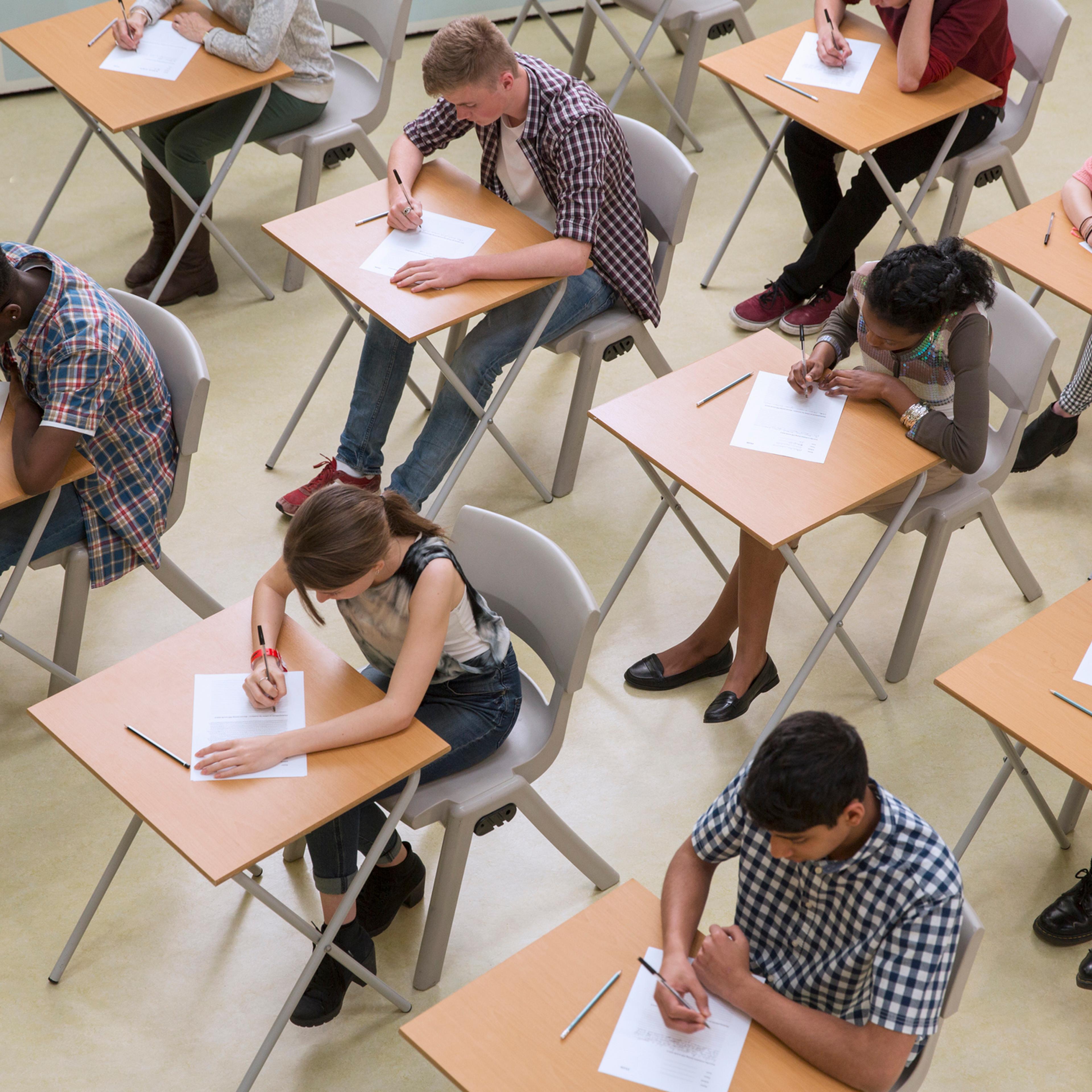 Elevated view of students writing their GCSE exam
