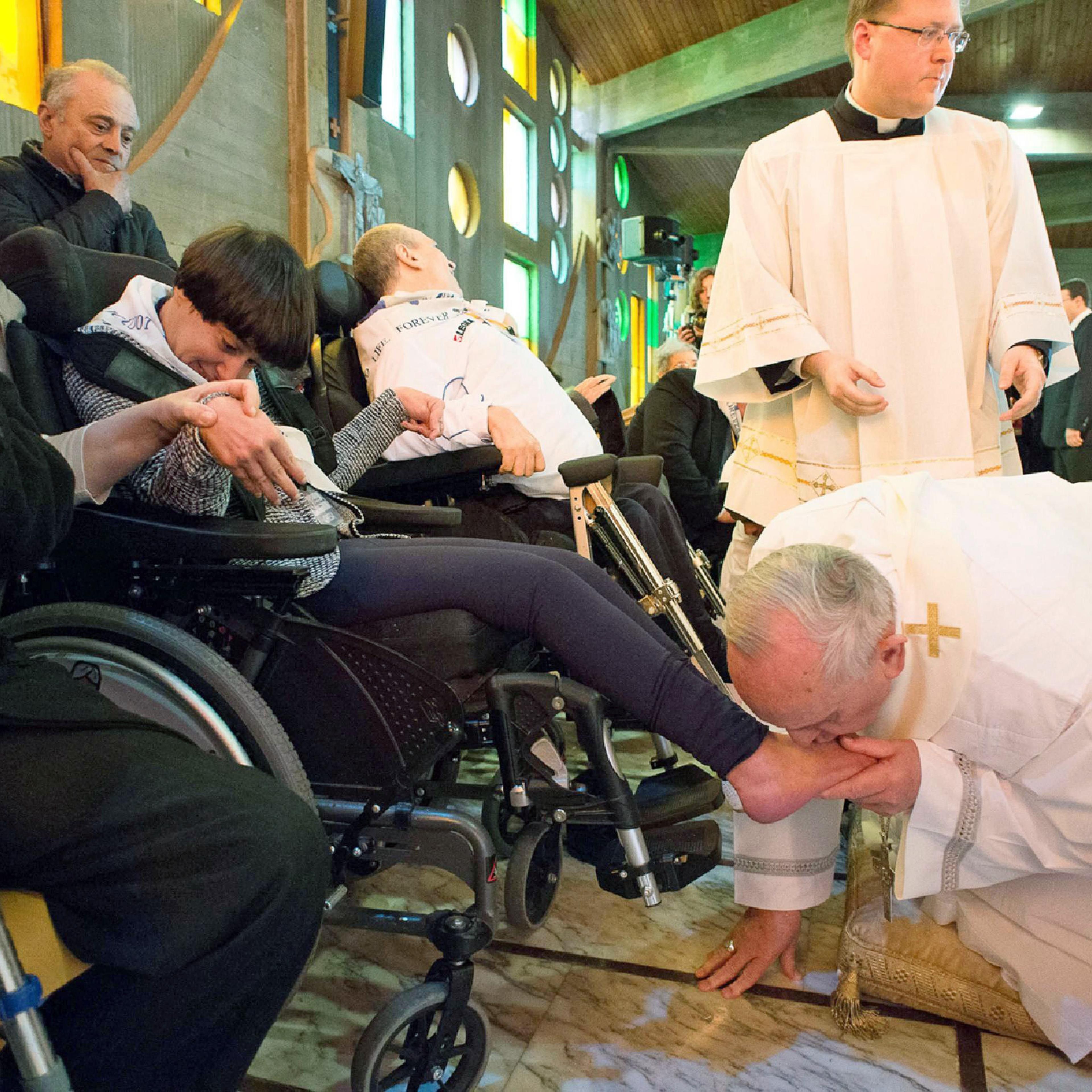 Pope Francis performs the traditional washing of the feet at the Don Carlo Gnocchi Foundation in Rome, on April 17, 2014.