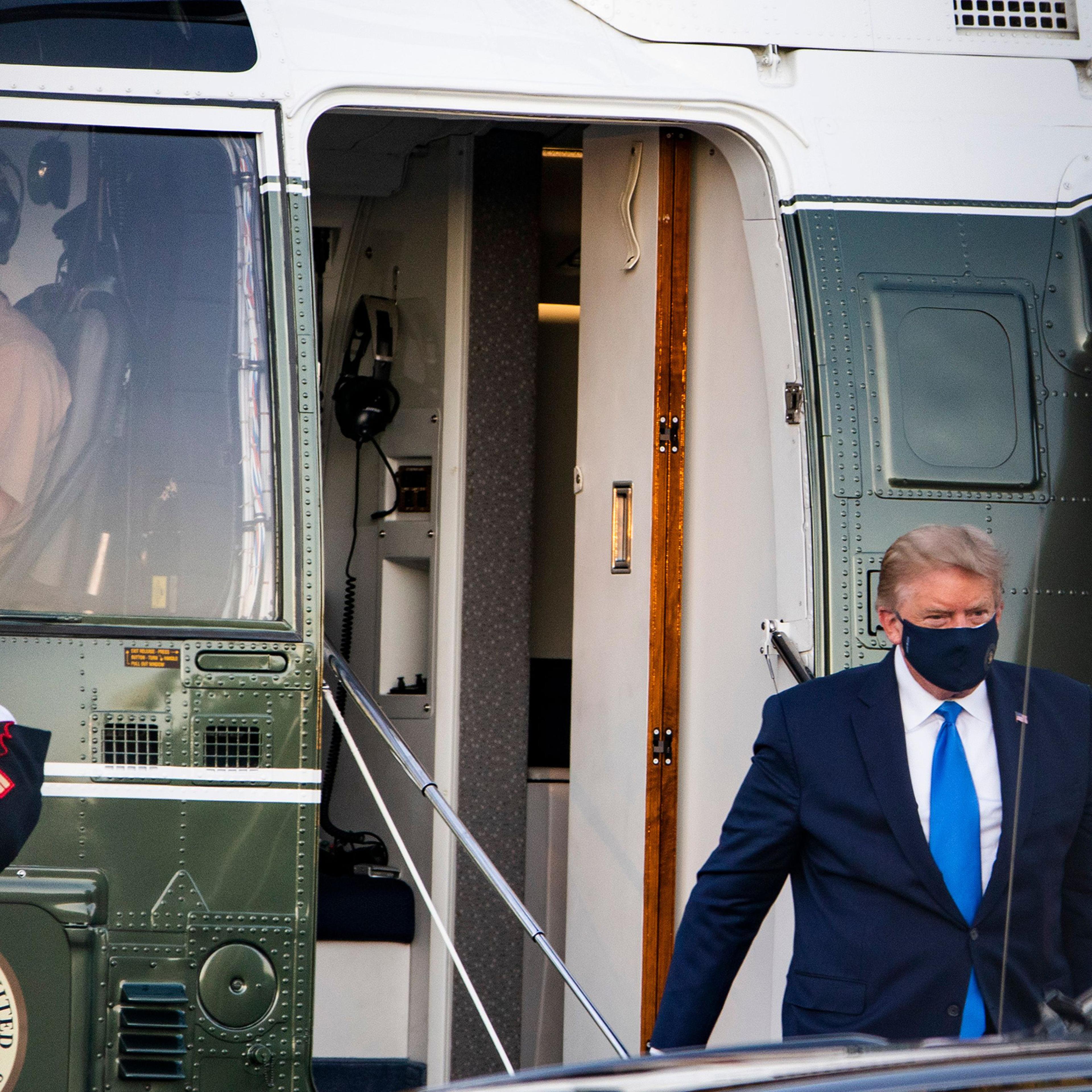 President Trump walks off Marine One after landing at Walter Reed National Military Medical Center in Bethesda, Md., on Oct. 2, 2020. His positive COVID-19 test comes after months of playing down the severity of the pandemic that has killed 207,000 Ameri