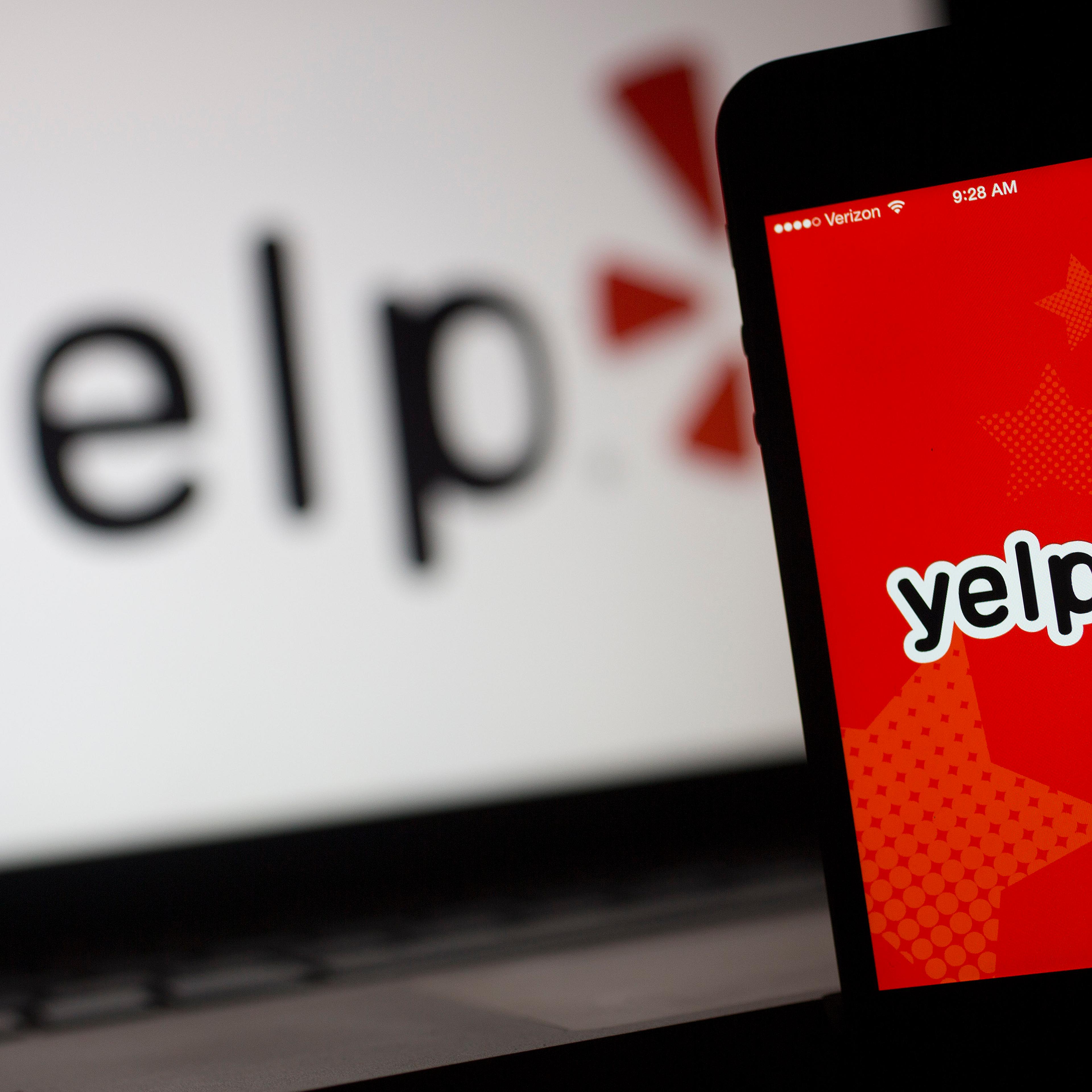 The Yelp Inc. application and logo are displayed on an Apple Inc. iPhone 5s and iPad Air in this arranged photograph in Washington, D.C., U.S., on Friday, April 25, 2014.