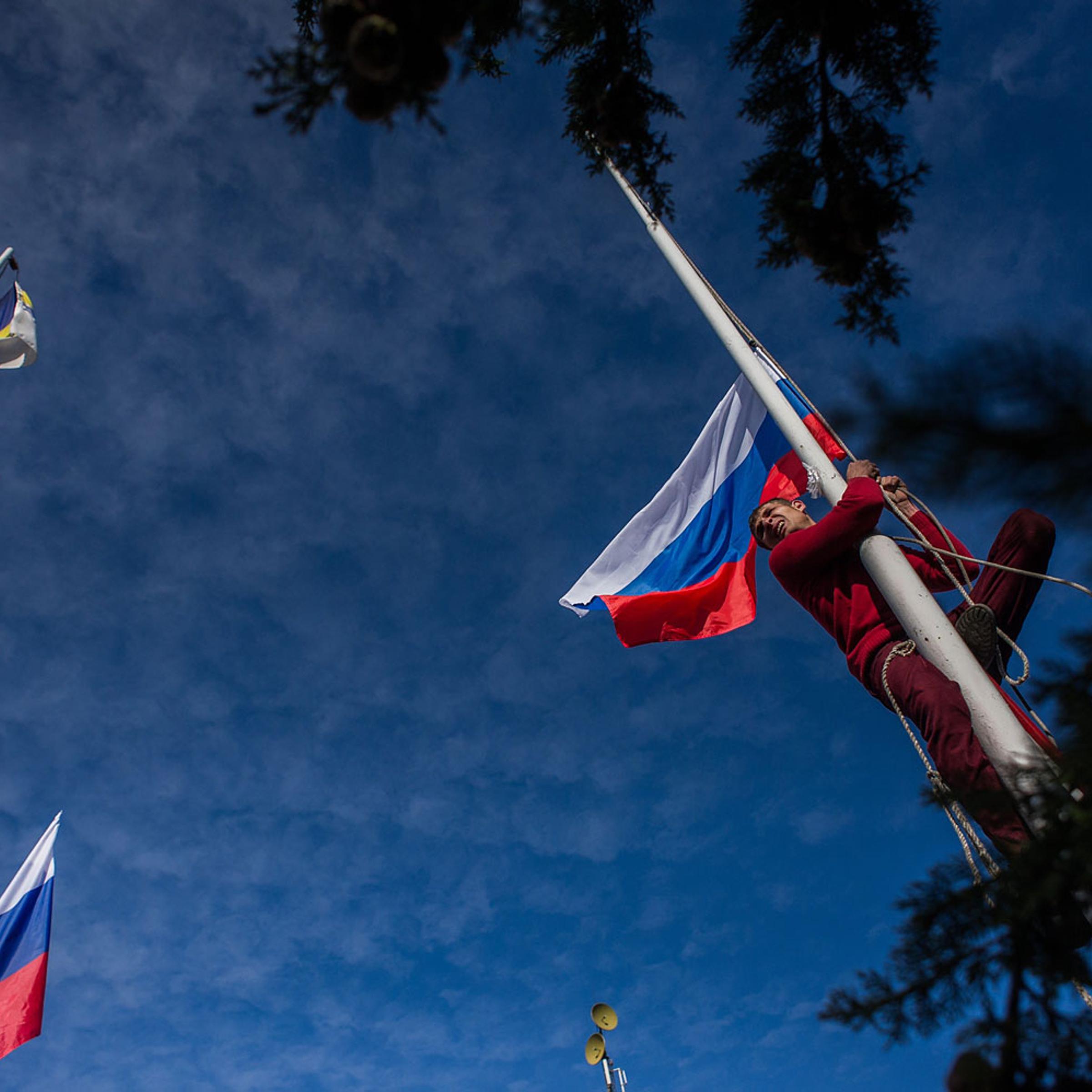 Russian President Vladimir Putin and Crimean Prime Minister Sergei Aksyonov attend a rally at Red Square on March 18, 2014 in Moscow.