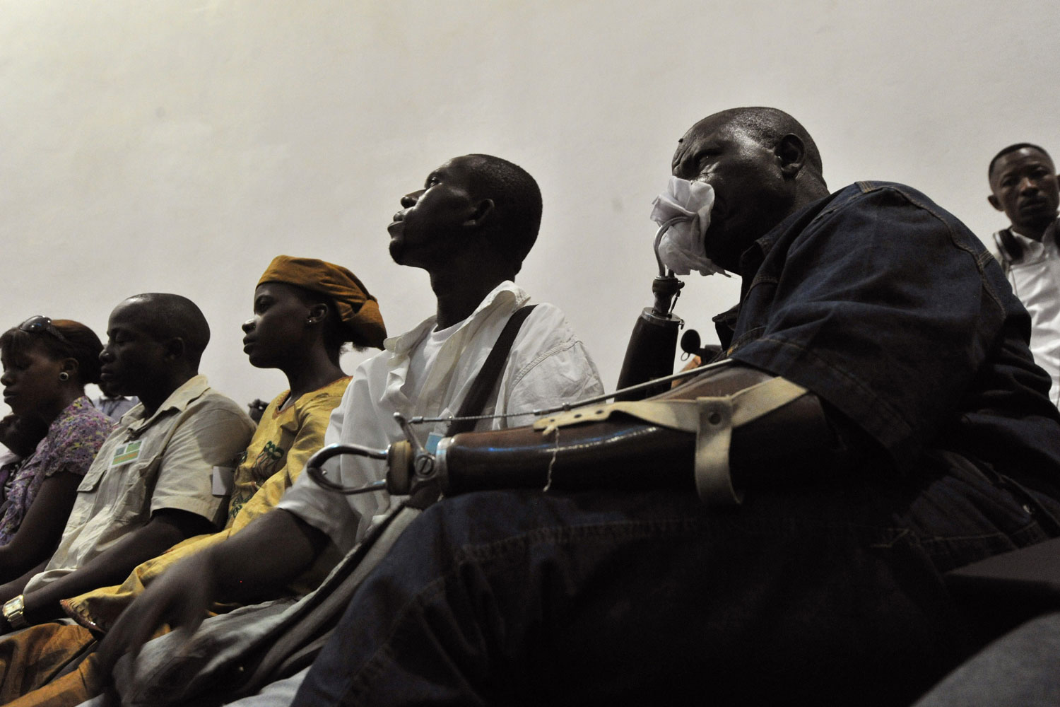 April 26, 2012. A victim watches a broadcast of the trial of Liberian ex-leader Charles Taylor, taking place in the Hague, inside the Special Court in Freetown, Liberia.