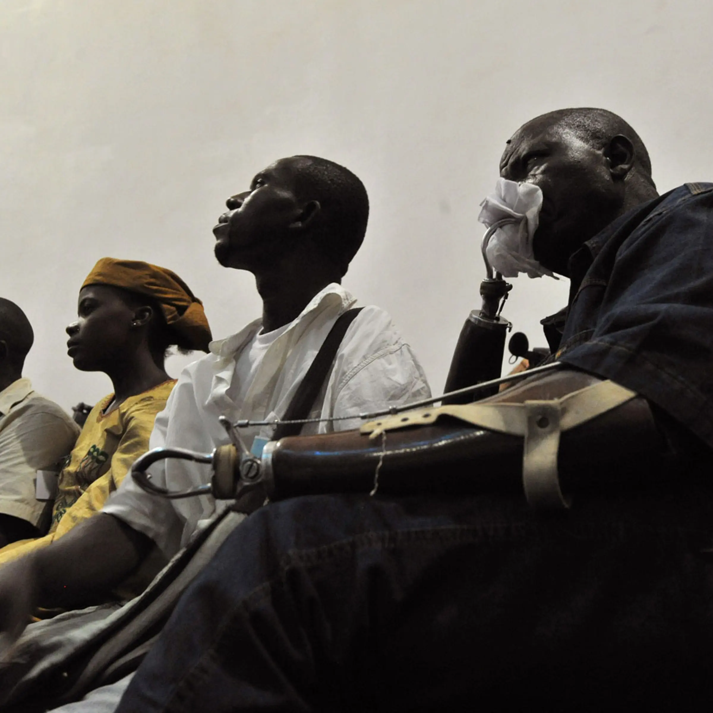 April 26, 2012. A victim watches a broadcast of the trial of Liberian ex-leader Charles Taylor, taking place in the Hague, inside the Special Court in Freetown, Liberia.