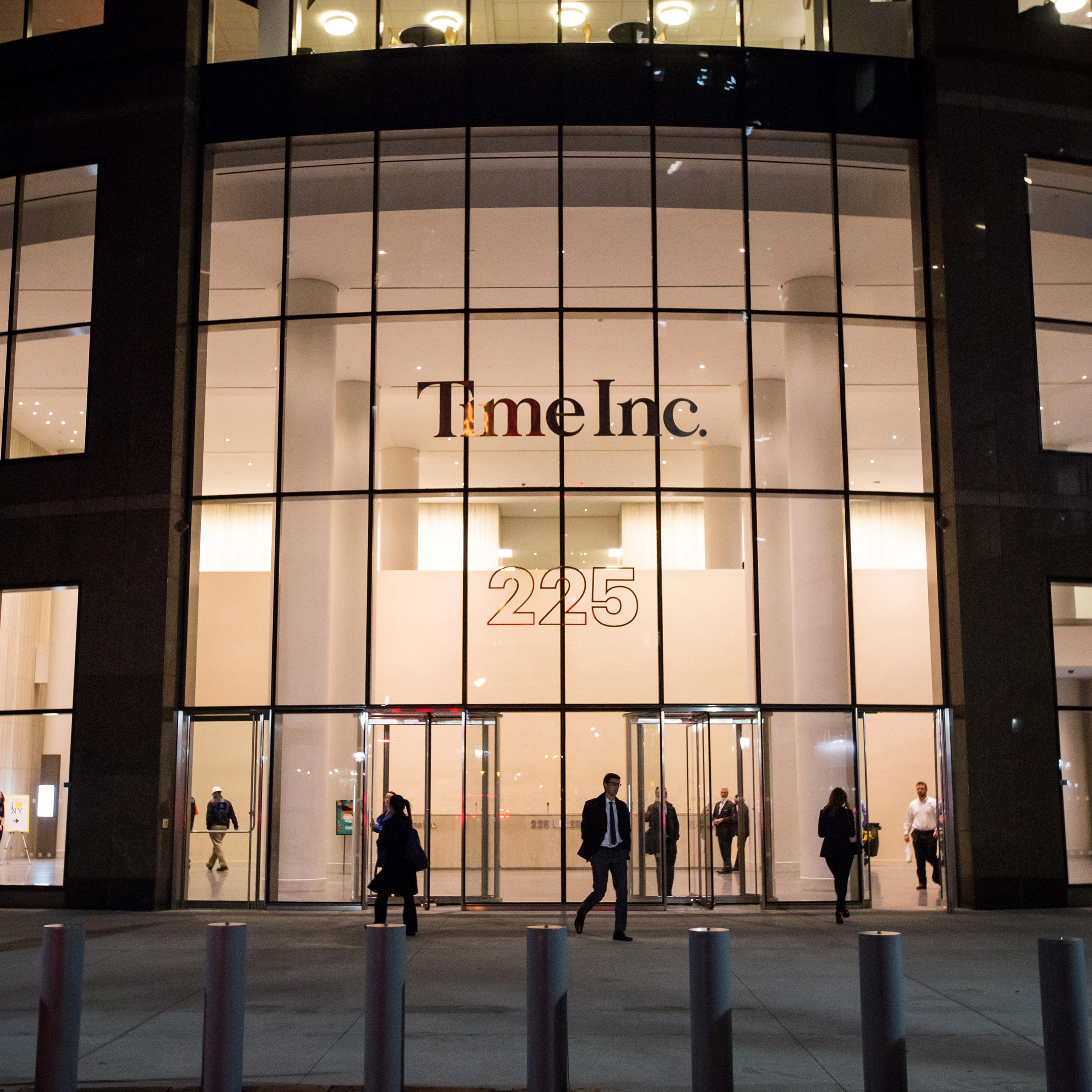Pedestrians walk past the new headquarters of Time Inc. in New York, N.Y, on Tuesday, Oct. 27, 2015.