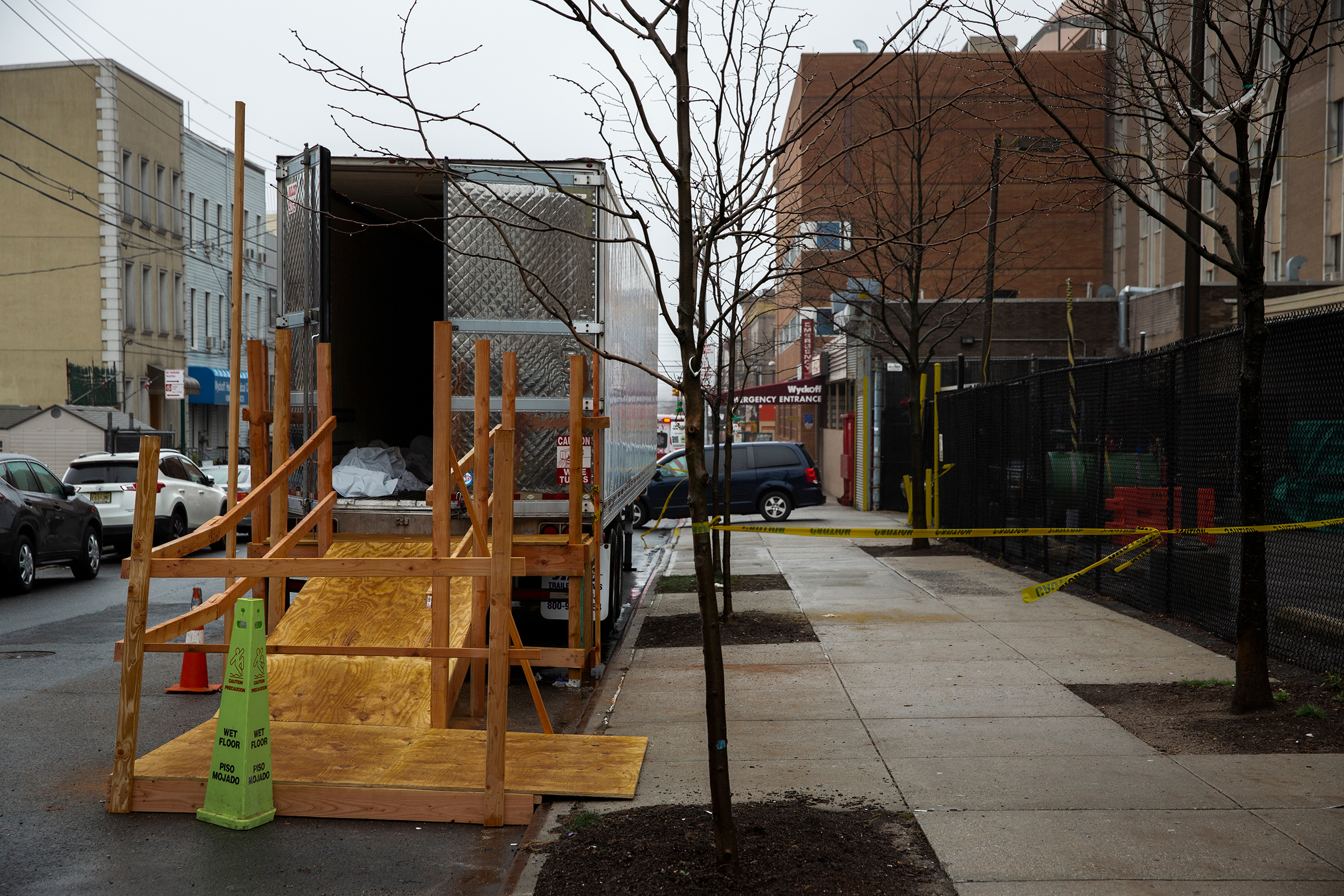 A covered body is seen in the back of a morgue truck parked outside Wyckoff Heights Medical Center in Brooklyn, New York, on March 29, 2020.