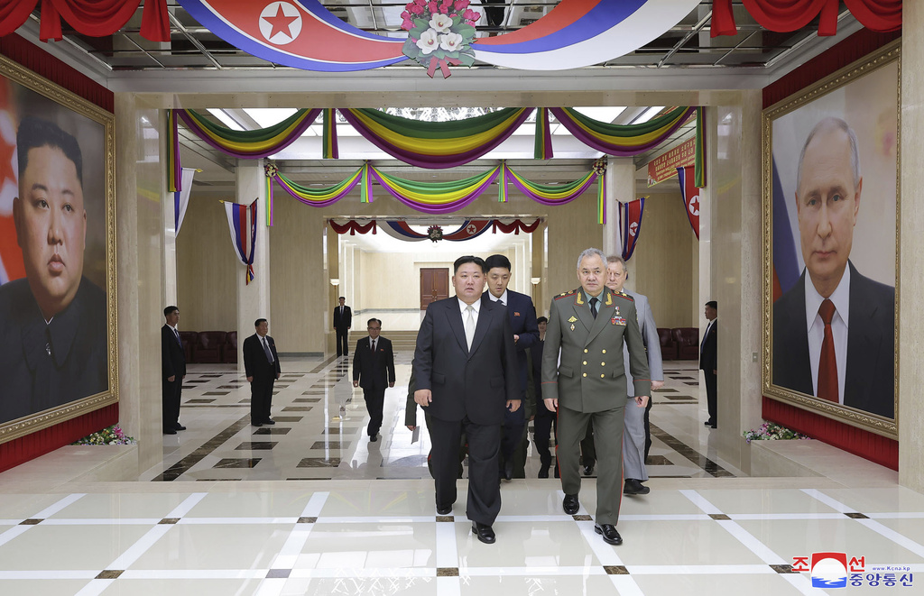 In this photo provided by the North Korean government, North Korean leader Kim Jong Un, center, and Russian Defense Minister Sergei Shoigu, left, head to a banquet hall, at the ruling Workers’ Party’s headquarters in Pyongyang, North Korea Thursday, July