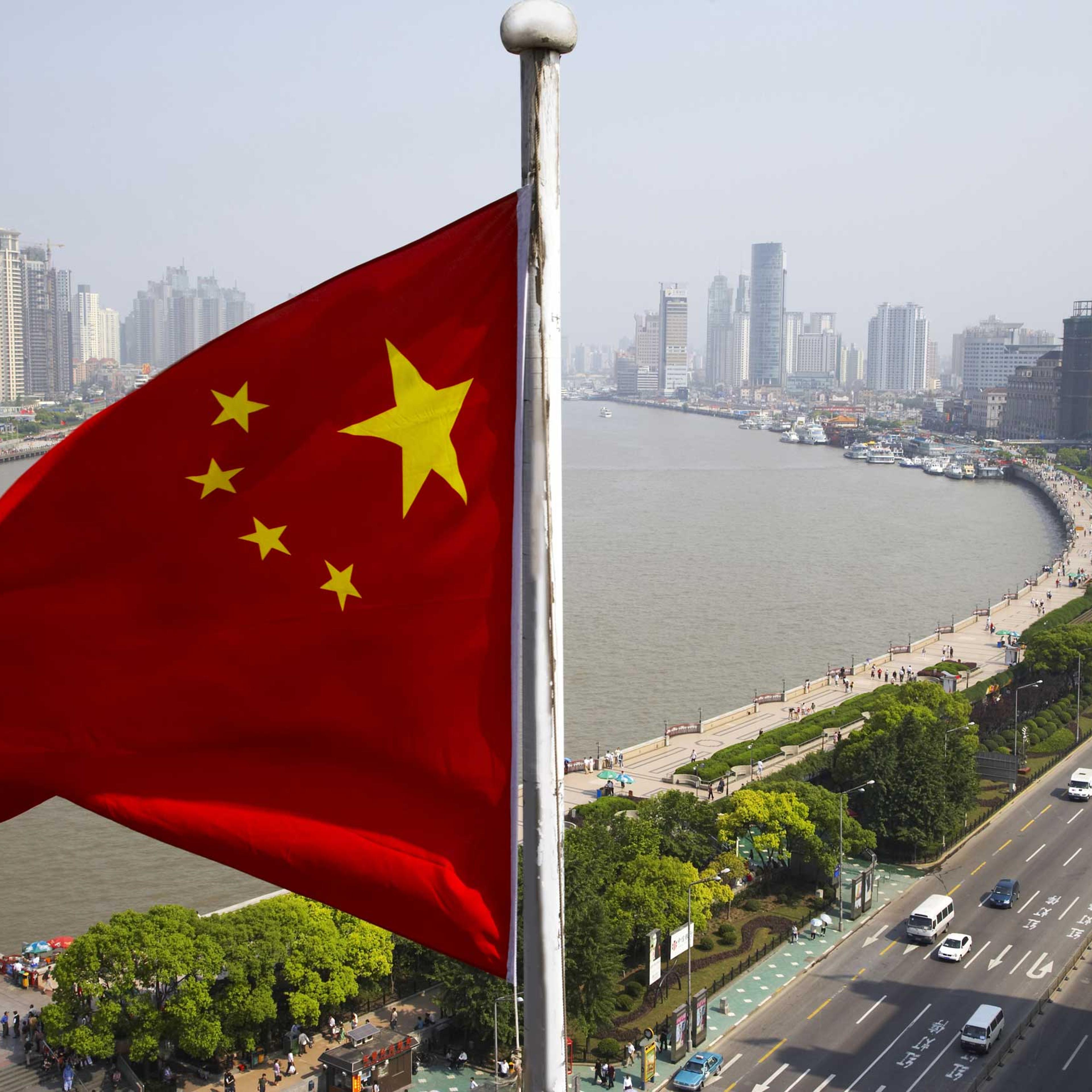 Chinese flag overlooking cityscape, Shanghai, China
