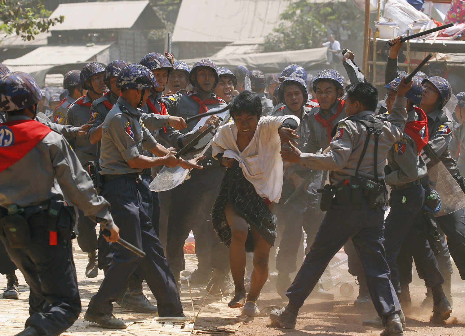 Police hit a student protester during violence in Letpadan