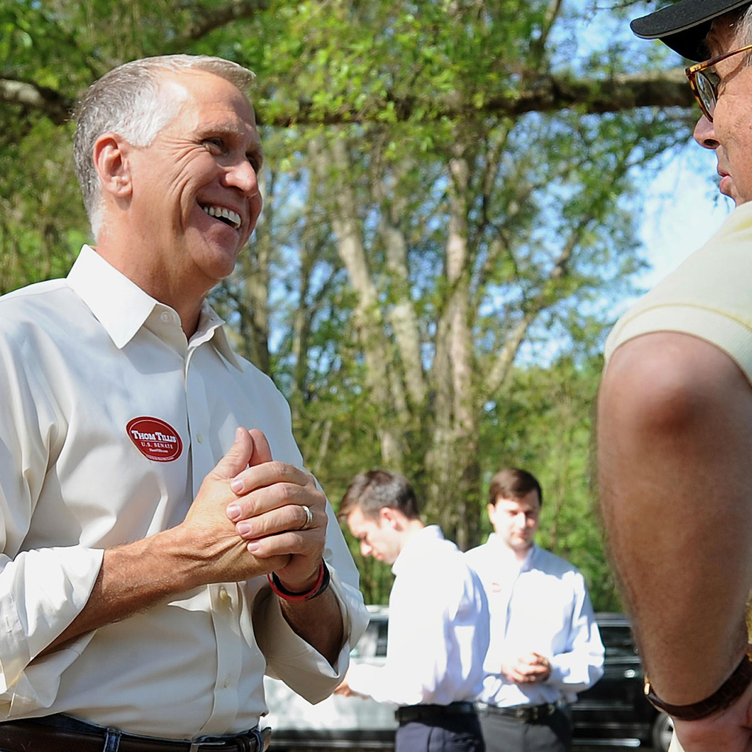 N.C. House Speaker Thom Tillis, left, talks with voter Donald Parrott of Charlotte outside Precinct 75 at Holy Covenant UCC in Charlotte, N.C., on May 6, 2014