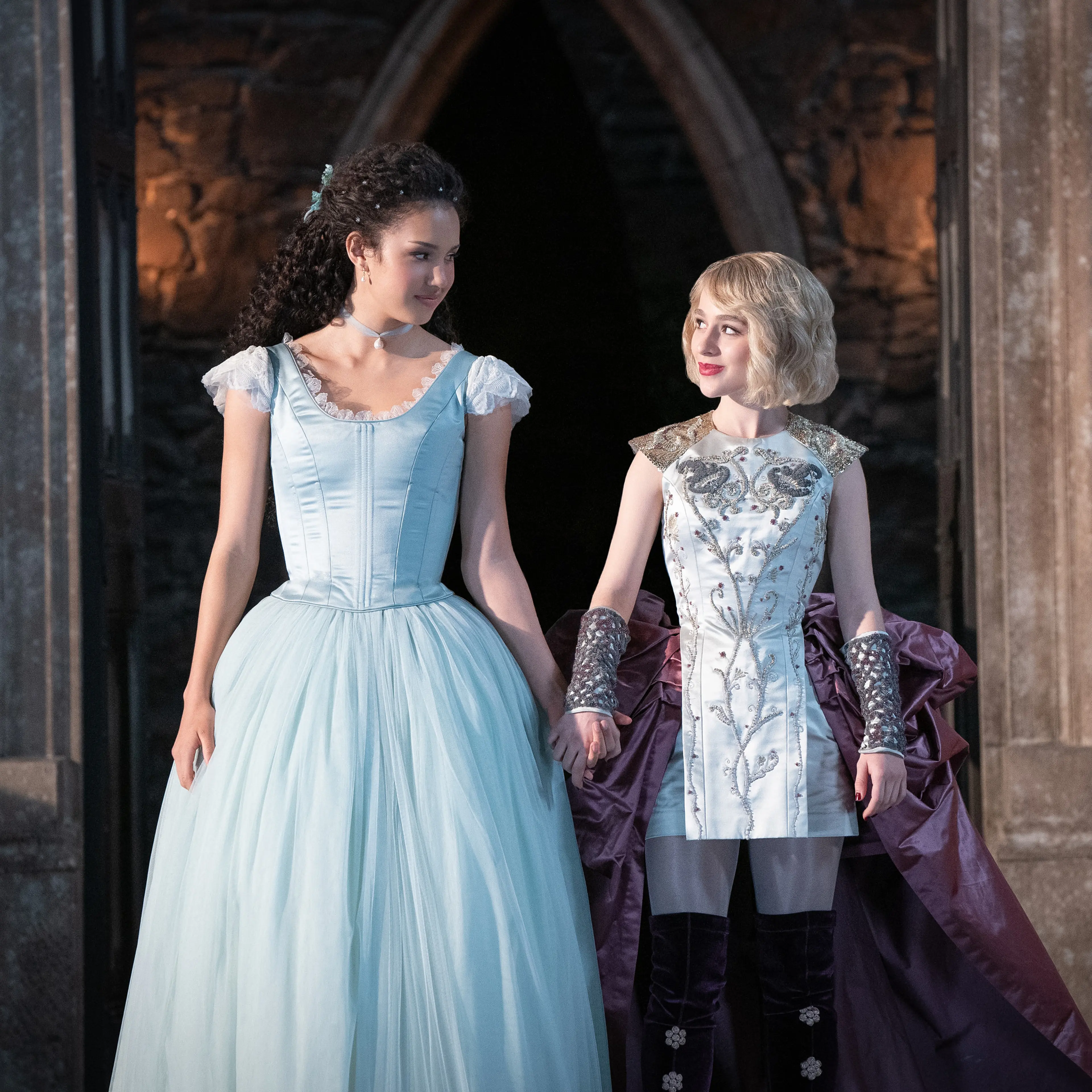 The two main characters standing in a doorway