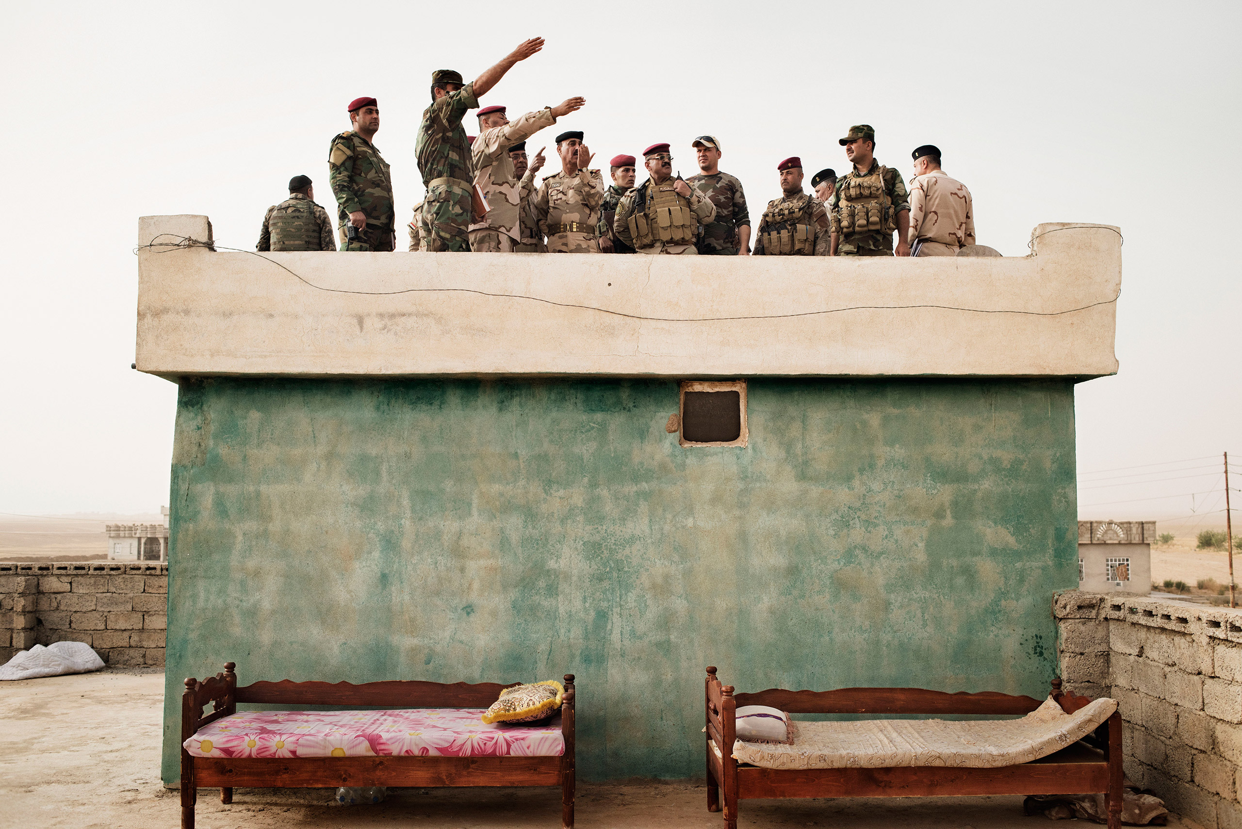 Iraqi Army commanders survey the front line in the villageof Kharbardan, south of Mosul, May 18, 2016. The Iraqi military seized the village from ISIS in March, as a part of a grinding march toward the city of Mosul, a major city that has been under ISIS control since June 2014.<br><br>From <a href="http://time.com/4372463/yuri-kozyrev-back-to-iraq/">"Yuri Kozyrev: On the Front Lines of the War Against ISIS"</a>