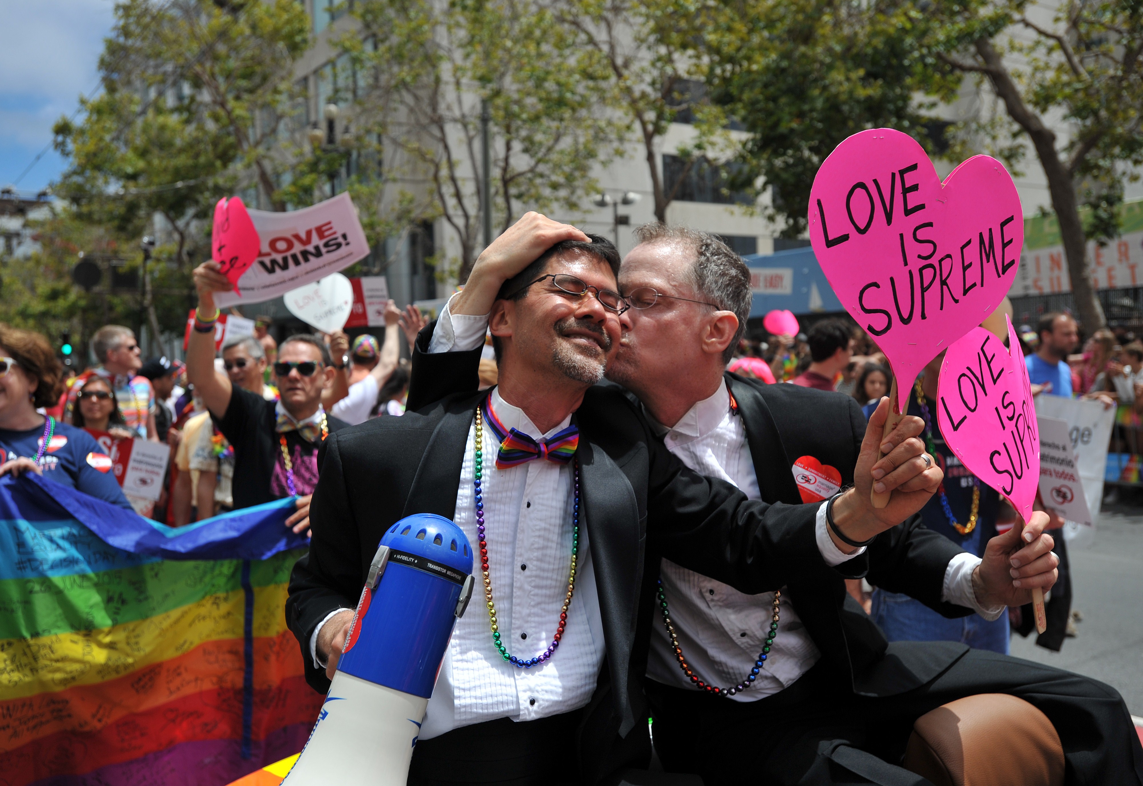 Stuart Gaffney (L) and John Lewis, plaintiffs in the 2008 Defense of Marriage Act (DOMA) case, celebrate while traveling along Market Street during the annual Gay Pride Parade in San Francisco, California on June 28, 2015, two days after the US Supreme C