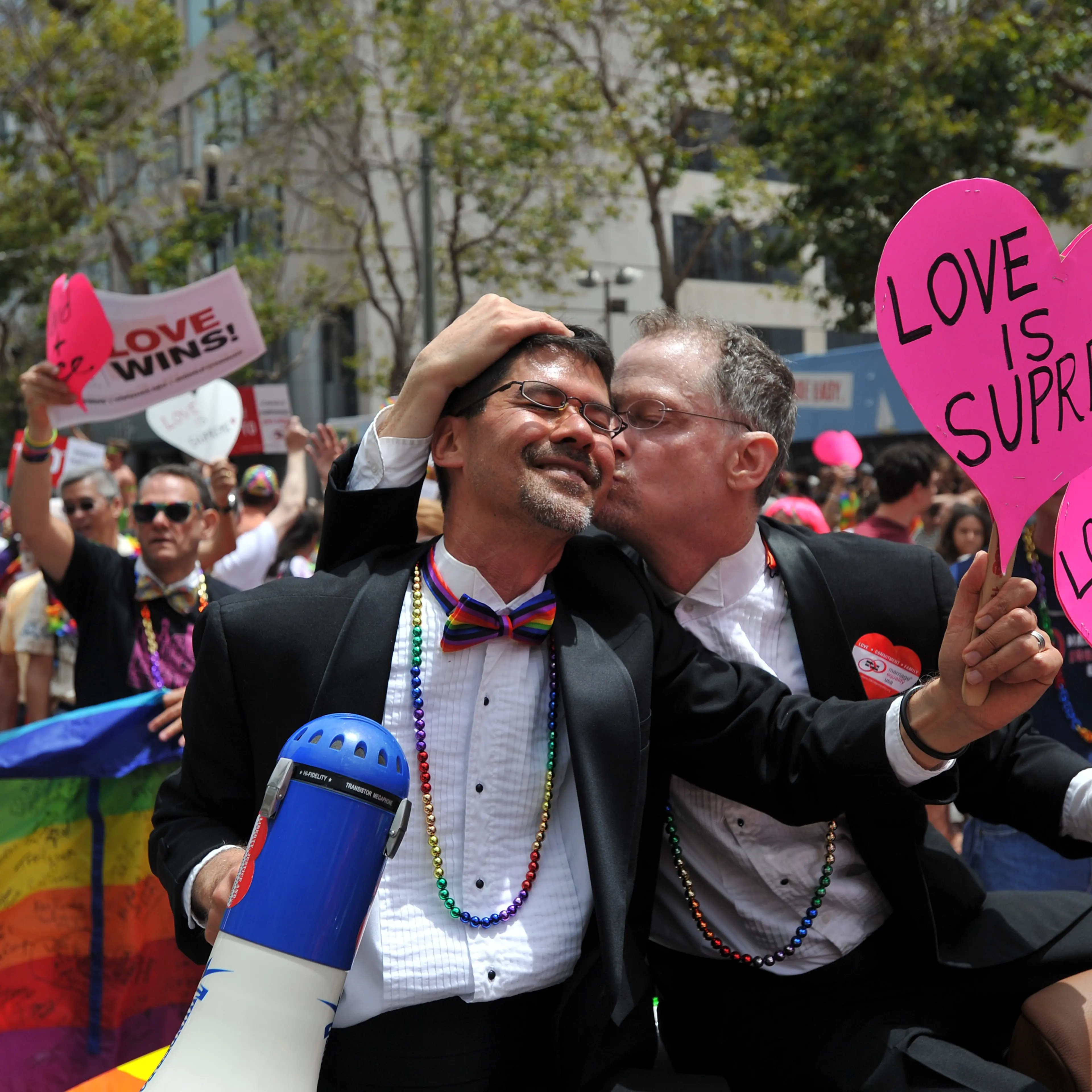 Stuart Gaffney (L) and John Lewis, plaintiffs in the 2008 Defense of Marriage Act (DOMA) case, celebrate while traveling along Market Street during the annual Gay Pride Parade in San Francisco, California on June 28, 2015, two days after the US Supreme C