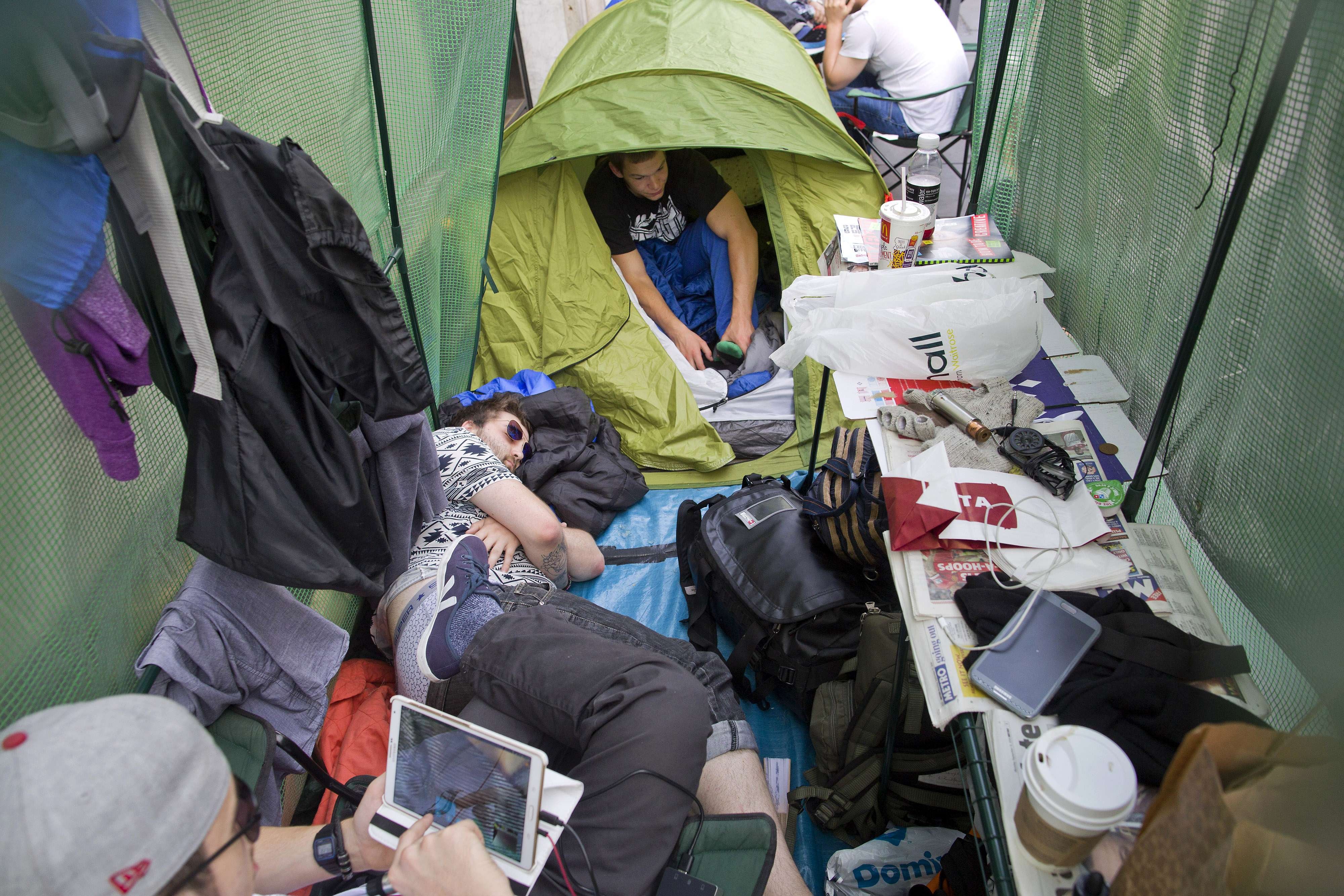 A man sleeps in a tent in the queue outside an Apple store in London on Sept. 18, 2014.