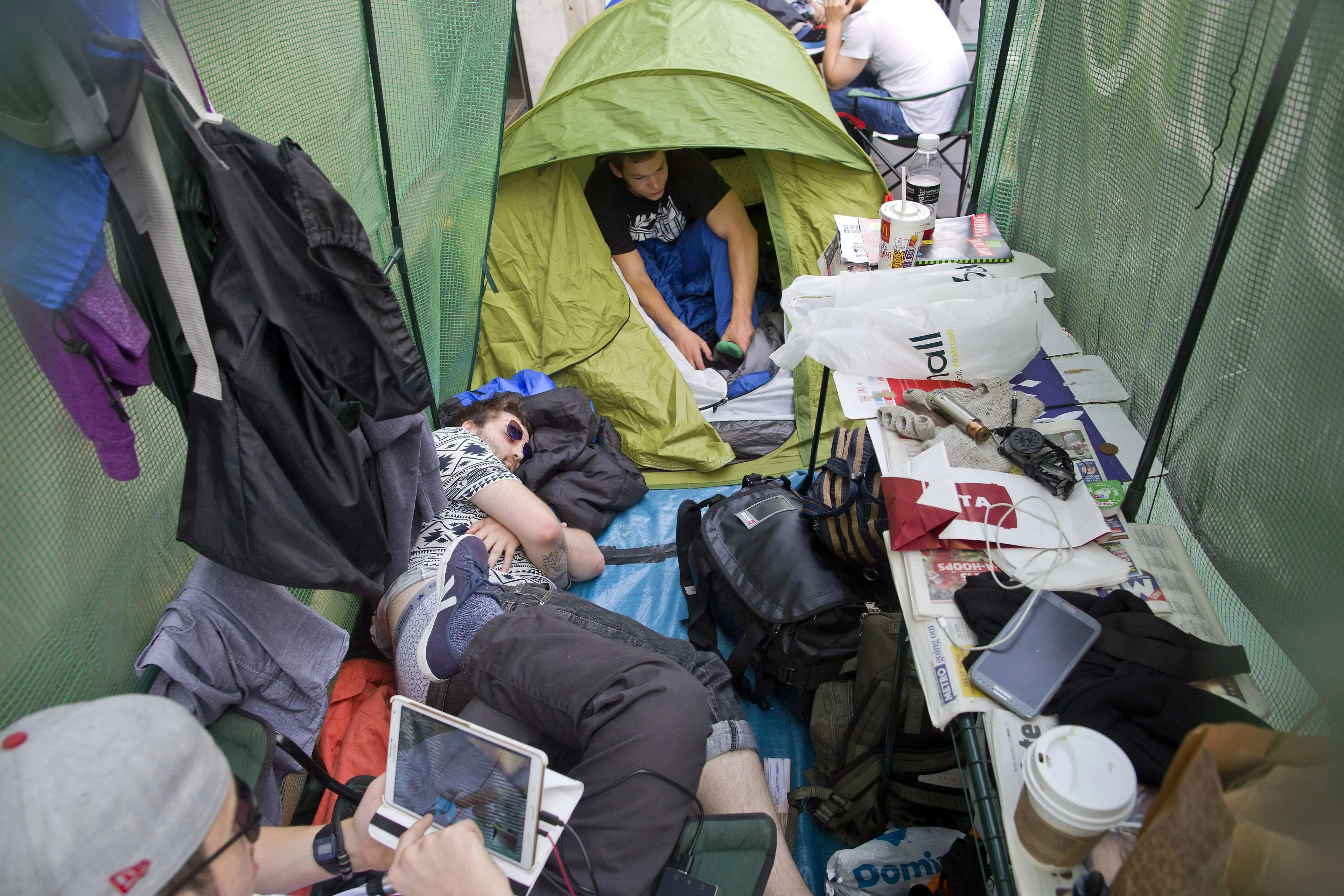 A man sleeps in a tent in the queue outside an Apple store in London on Sept. 18, 2014.