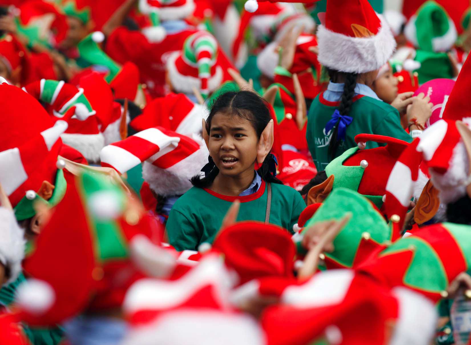 Students gather to break the Guinness World Record for the largest gathering of Christmas elves outside a shopping mall in Bangkok on Nov. 25, 2014 