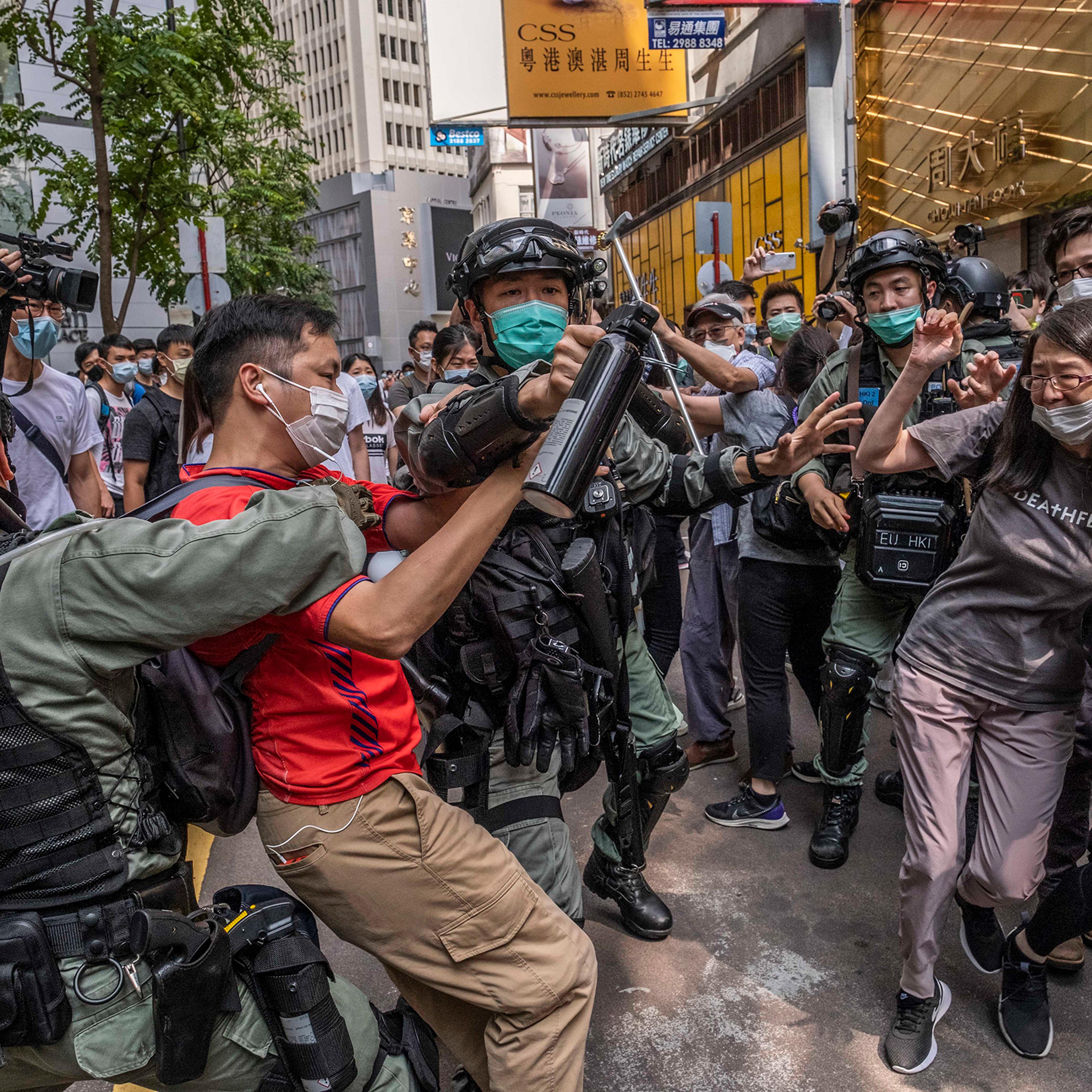 Riot police officers clash with protesters in Hong Kong on May 27, 2020.