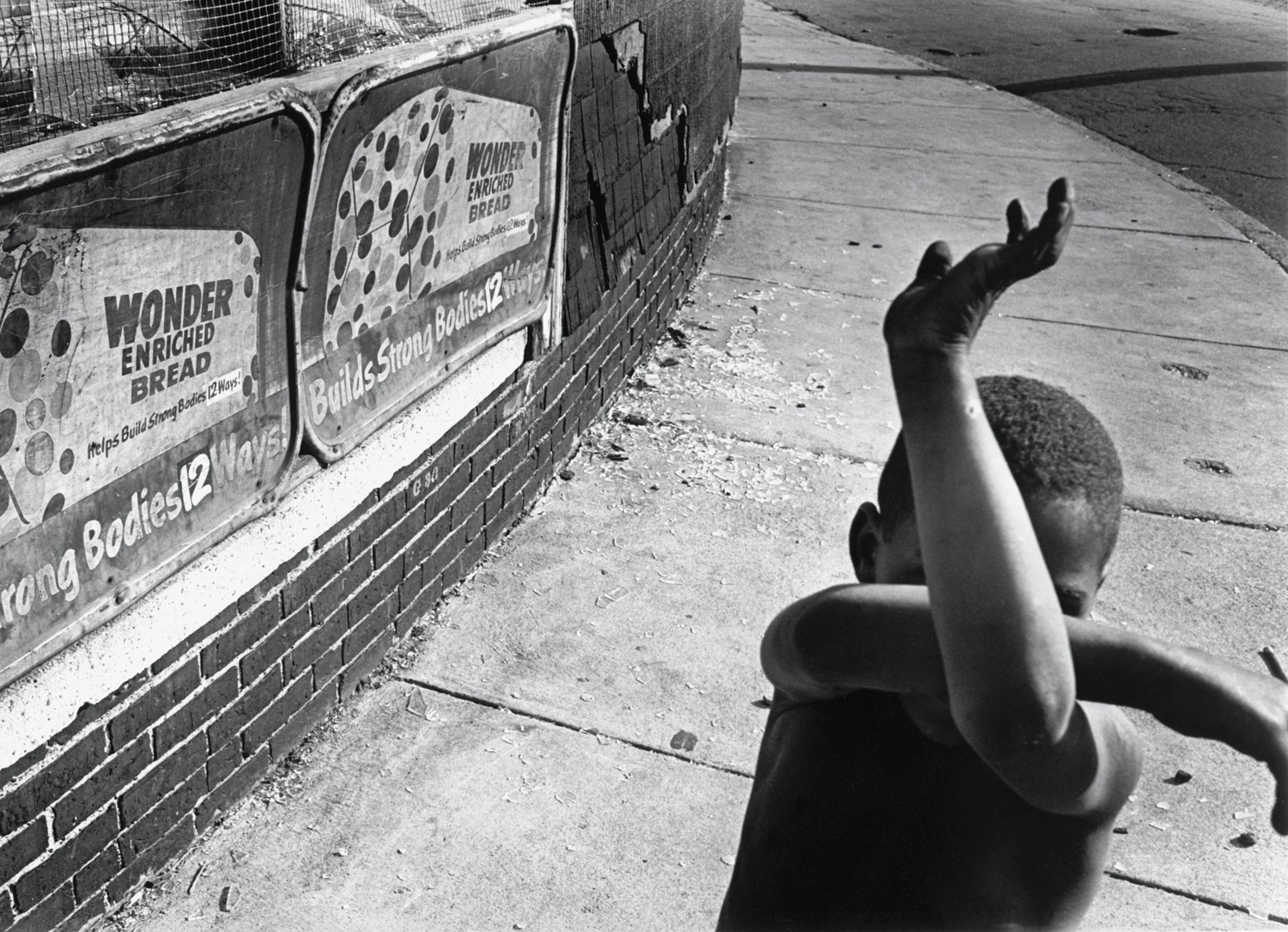 <b><i>Wonder Bread, Dorchester, Massachusetts</i>, by Eugene Richards, 1975/1997.</b><br>

"A great street picture that has some political overtones. It speaks of youth and the potential of life—I love the way his arms are criss-crossed in this funny little matrix. This is a picture full of wonder, and at the same time, dread of what the future is."