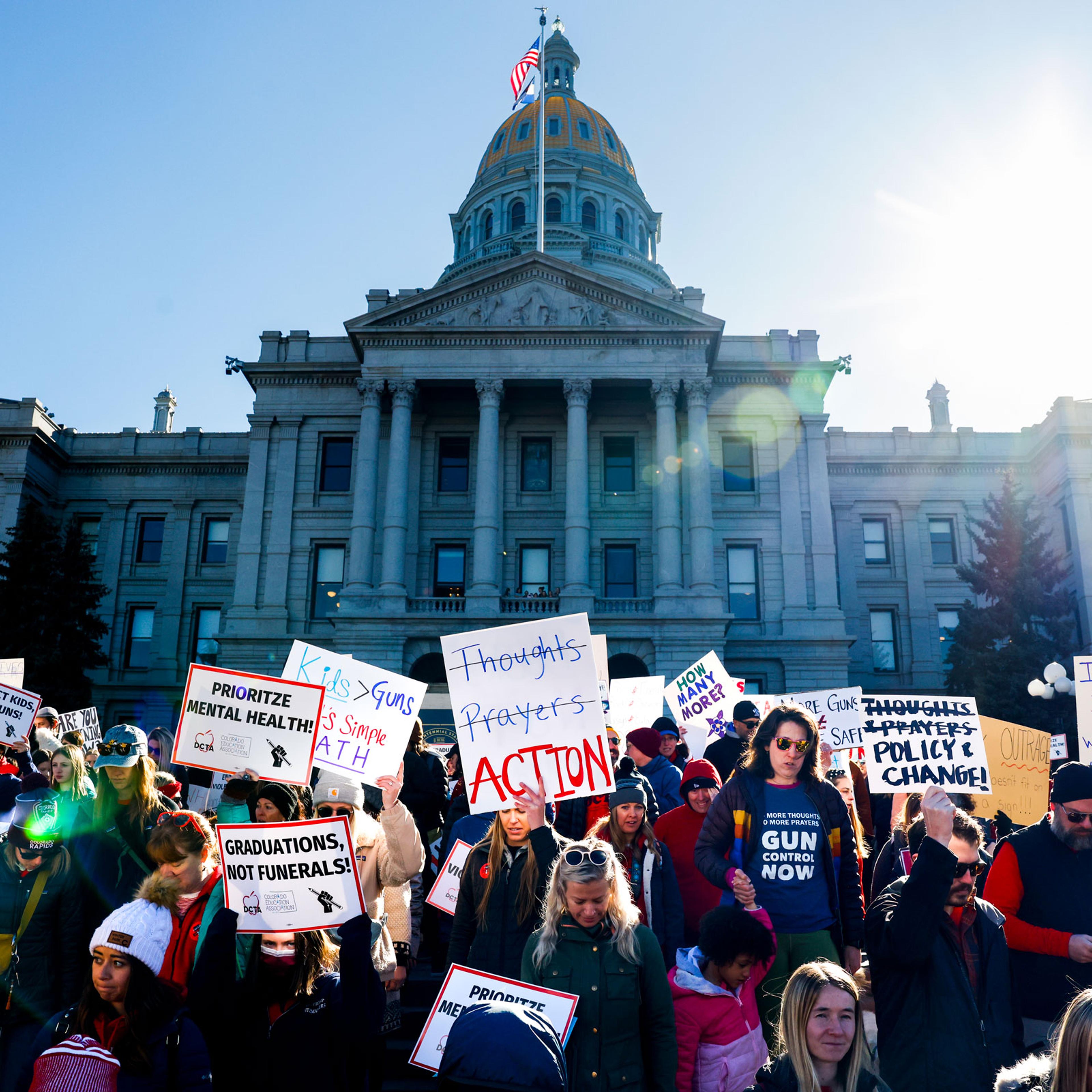 People march around the Colorado State Capitol during a protest to end gun violence