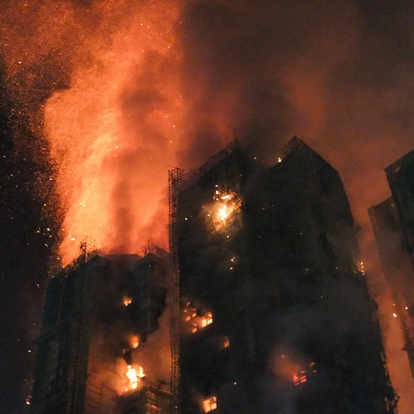 Thick smoke and flames rise as a major fire engulfs several apartment blocks at the Wang Fuk Court residential estate in Hong Kong's Tai Po district on Nov. 26, 2025.