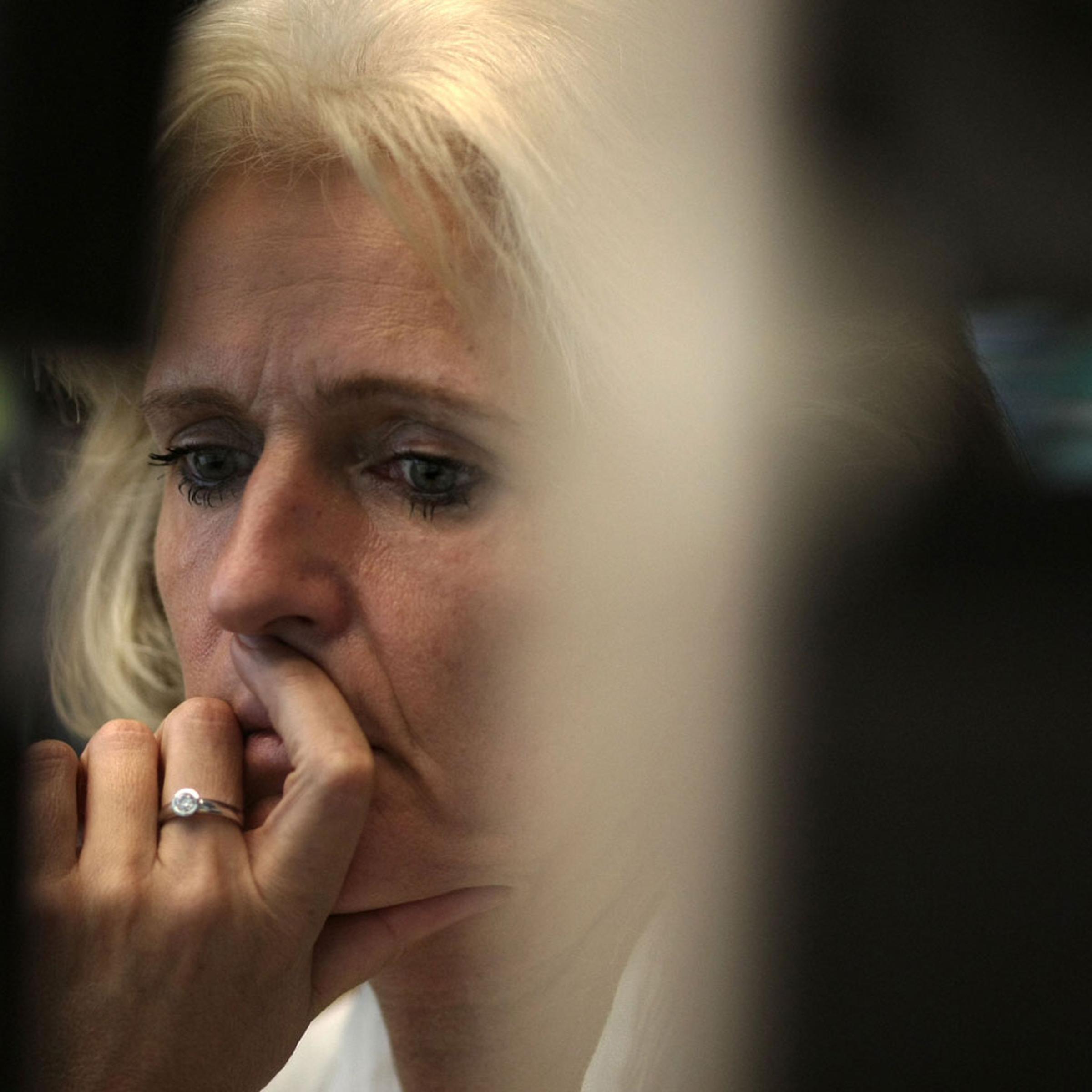 A trader looks to the German DAX stock index at the stock exchange in Frankfurt/Main, Germany, August 9, 2011. Shortly after the Dax indicated a positive trend the index temporarily fell by 7 per cent.