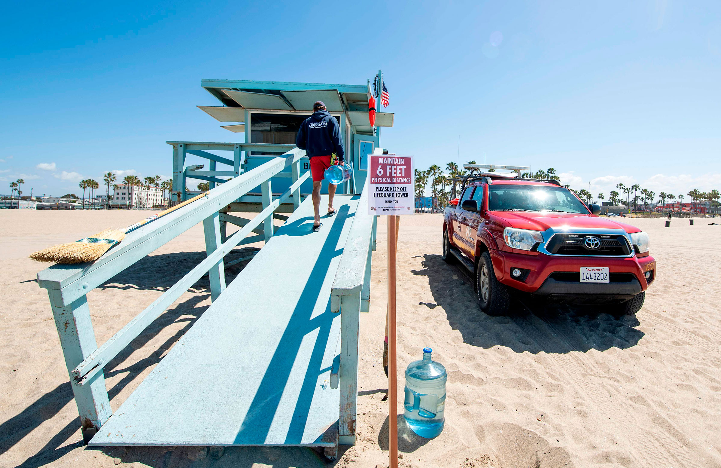 A lifeguard opens his tower in Venice Beach on the first day Los Angeles County allowed beaches to reopen after a six-week closure implemented to stop the spread of the coronavirus