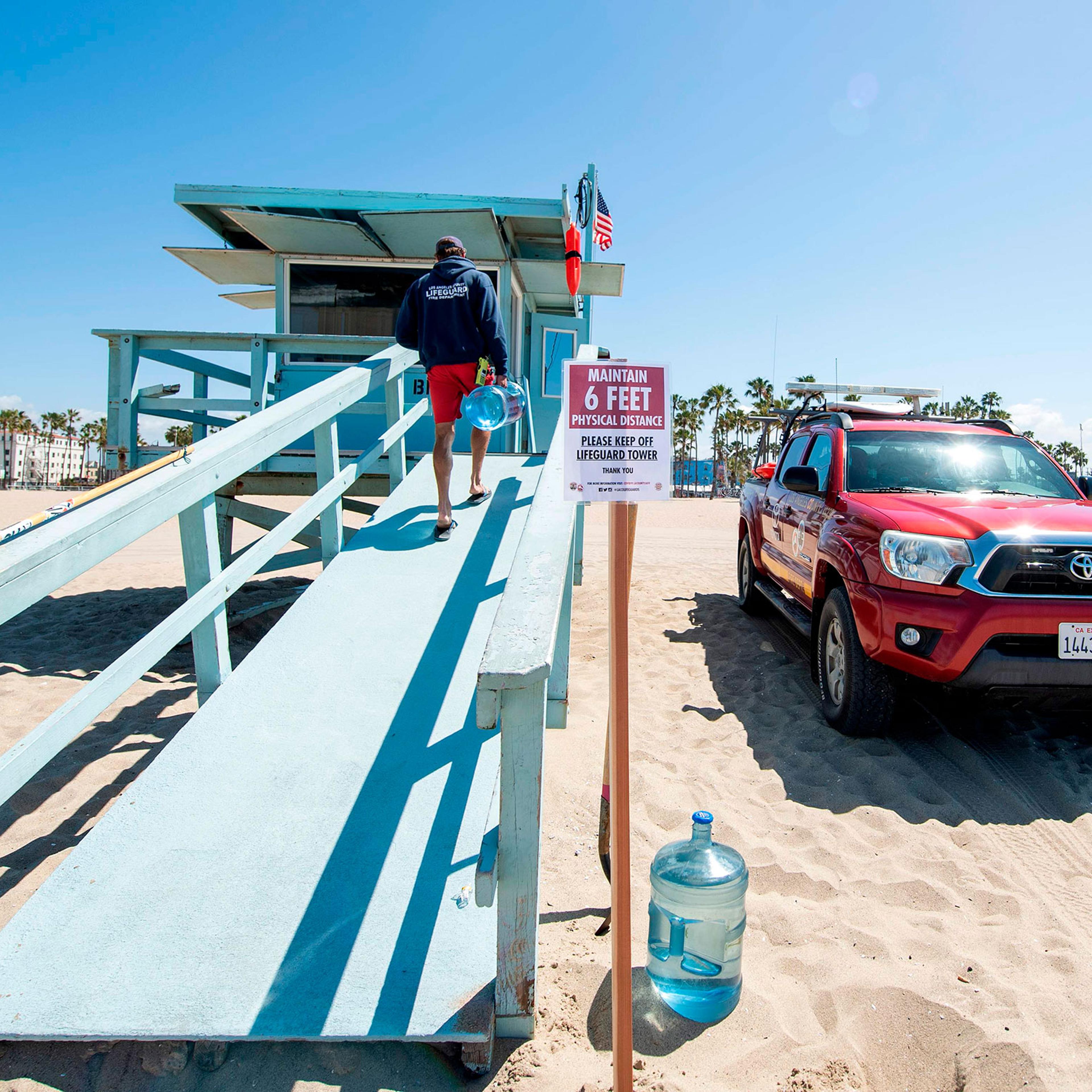 A lifeguard opens his tower in Venice Beach on the first day Los Angeles County allowed beaches to reopen after a six-week closure implemented to stop the spread of the coronavirus