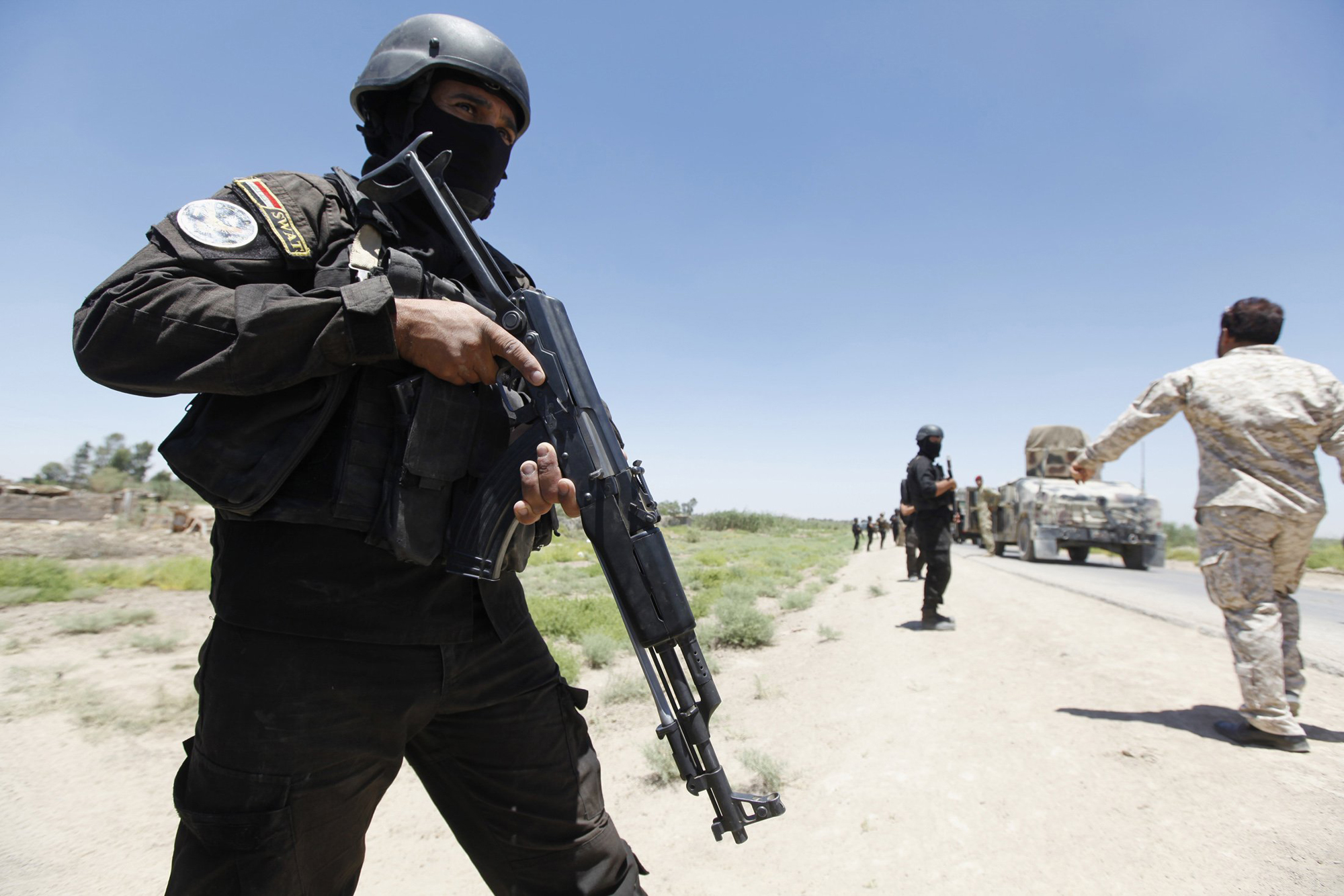 Members of the Iraqi security forces take their positions during an intensive security deployment west of Baghdad, June 24, 2014.