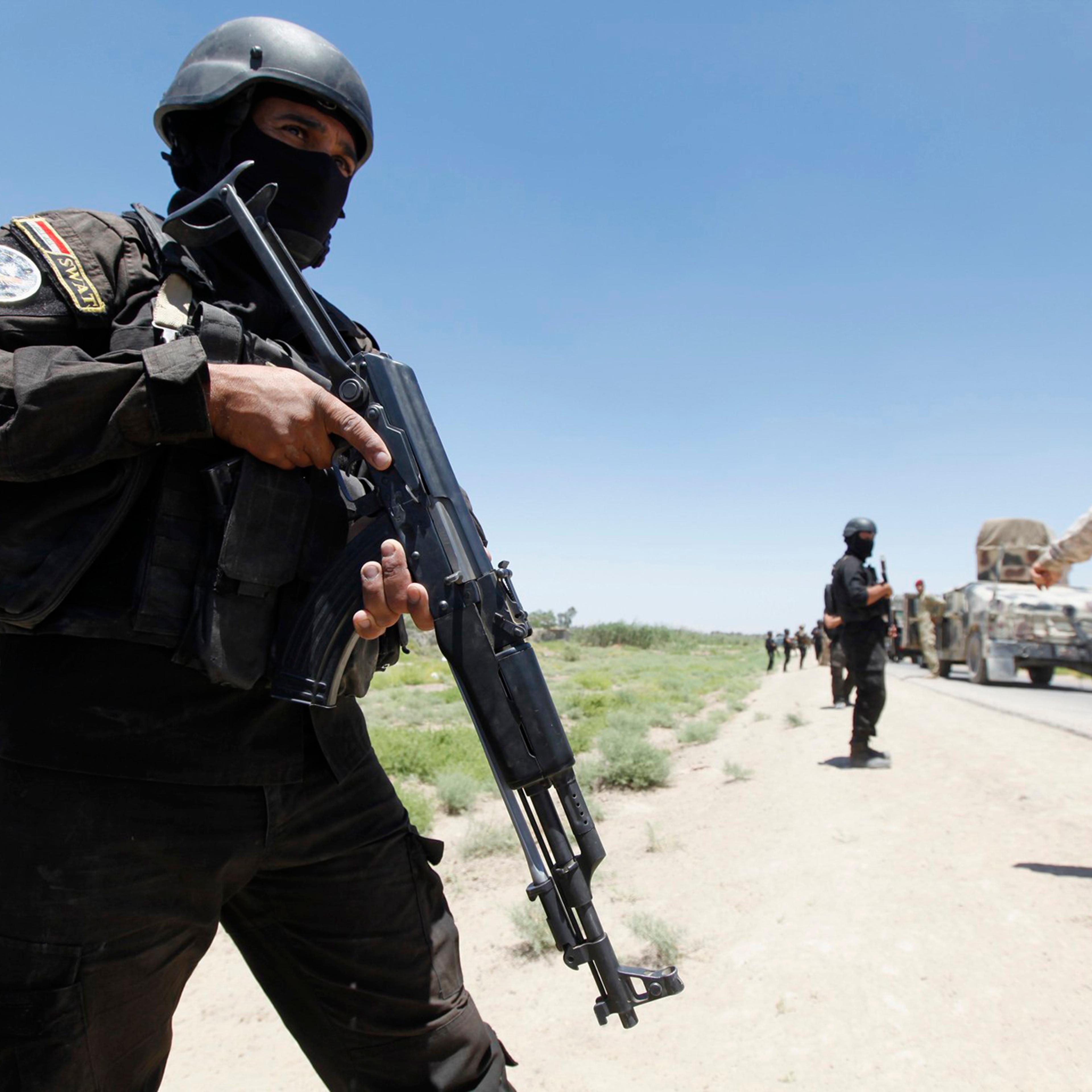 Members of the Iraqi security forces take their positions during an intensive security deployment west of Baghdad, June 24, 2014.