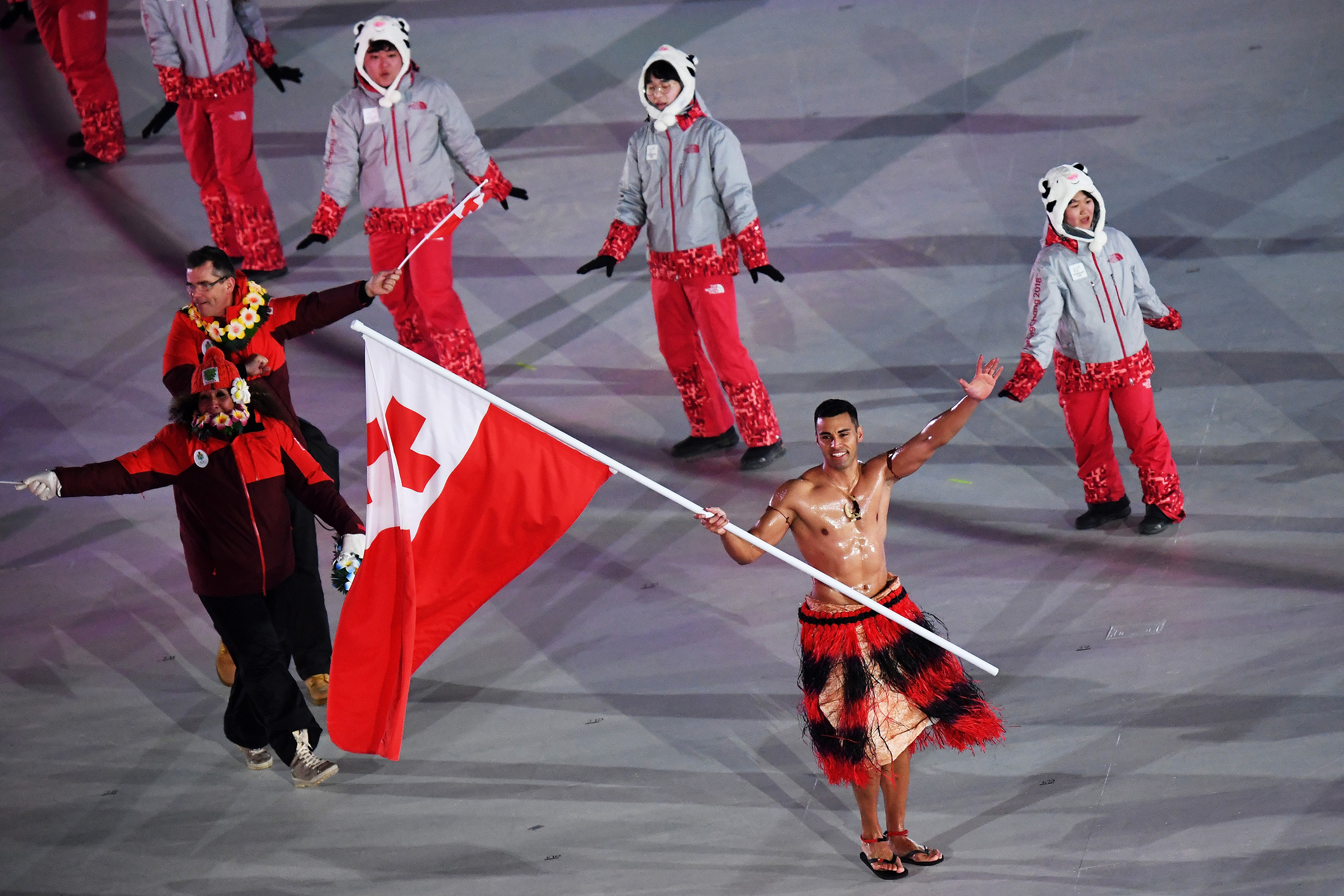 Flag bearer Pita Taufatofua of Tonga and teammates enter the stadium during the Opening Ceremony of the PyeongChang 2018 Winter Olympic Games at PyeongChang Olympic Stadium on Feb. 9, 2018.