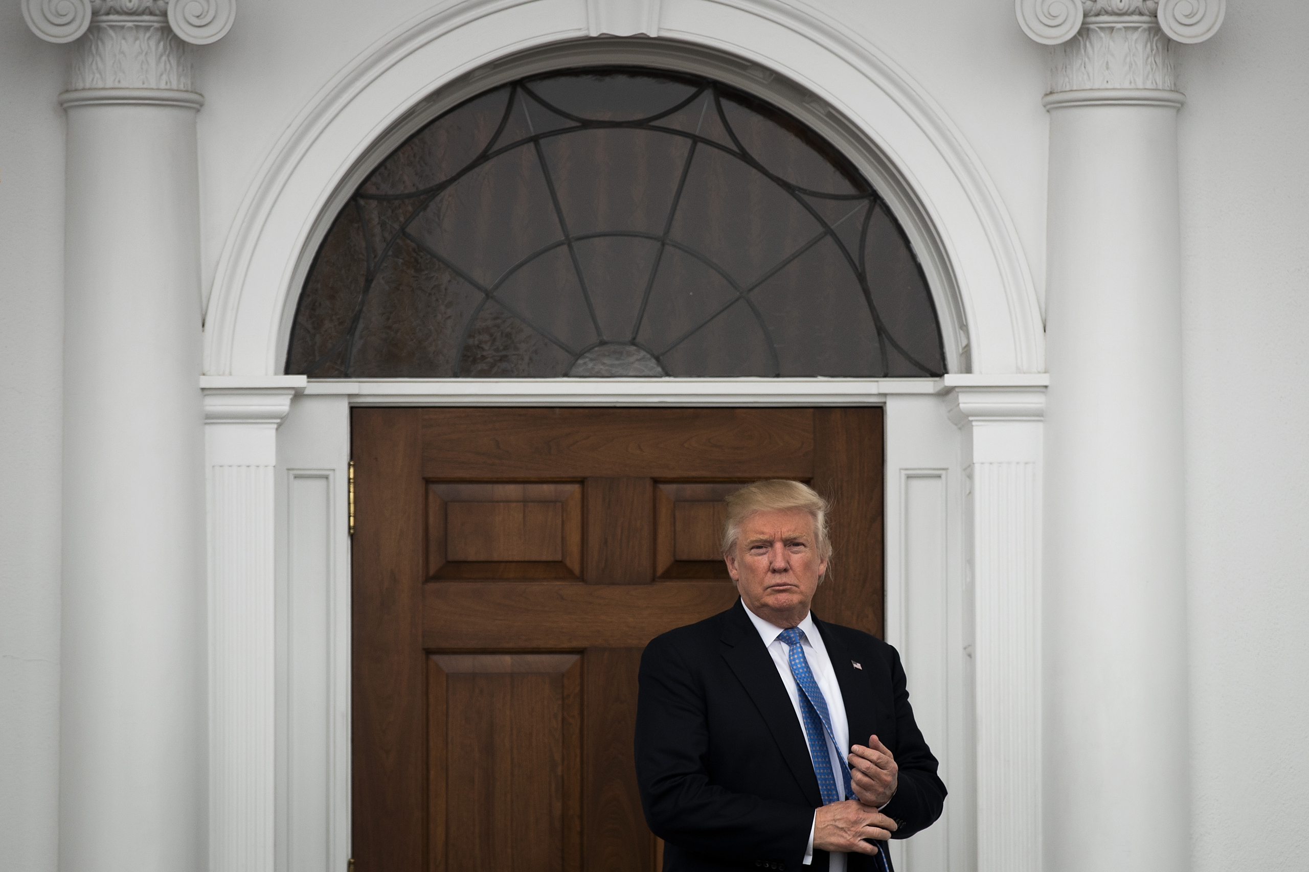 BEDMINSTER TOWNSHIP, NJ - NOVEMBER 20: President-elect Donald Trump stands outside the clubhouse following his meeting with Peter Kirsanow, attorney and member of the U.S. Commission on Civil Rights, at Trump International Golf Club, November 20, 2016 in