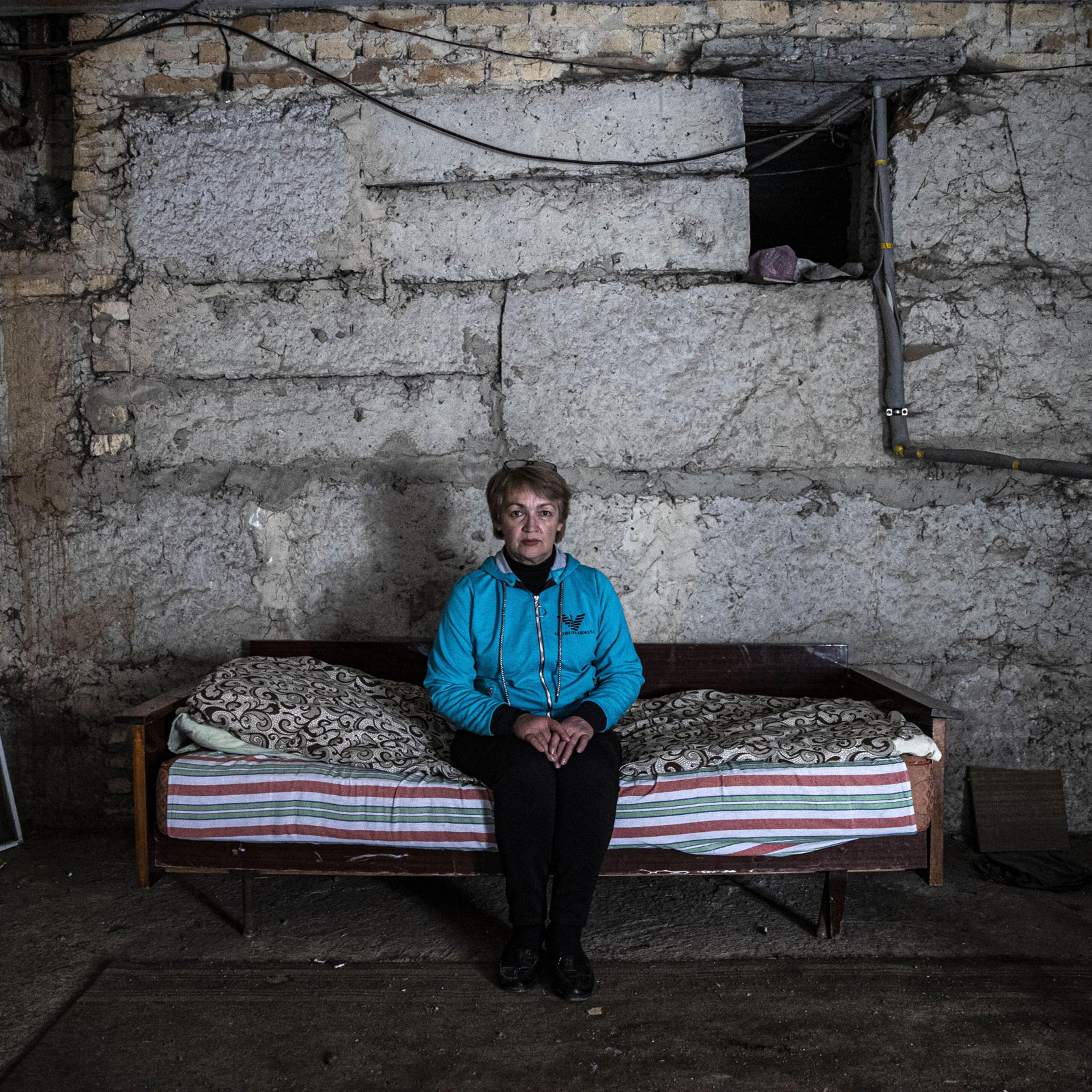 A woman whose house was destroyed in an attack stays in a bomb shelter in Krasnohorivka, in Donetsk Oblast, Ukraine, on Sept. 29, 2022. Residents of the city had to live in bomb shelters due to the ongoing war as power and gas disruption continues.