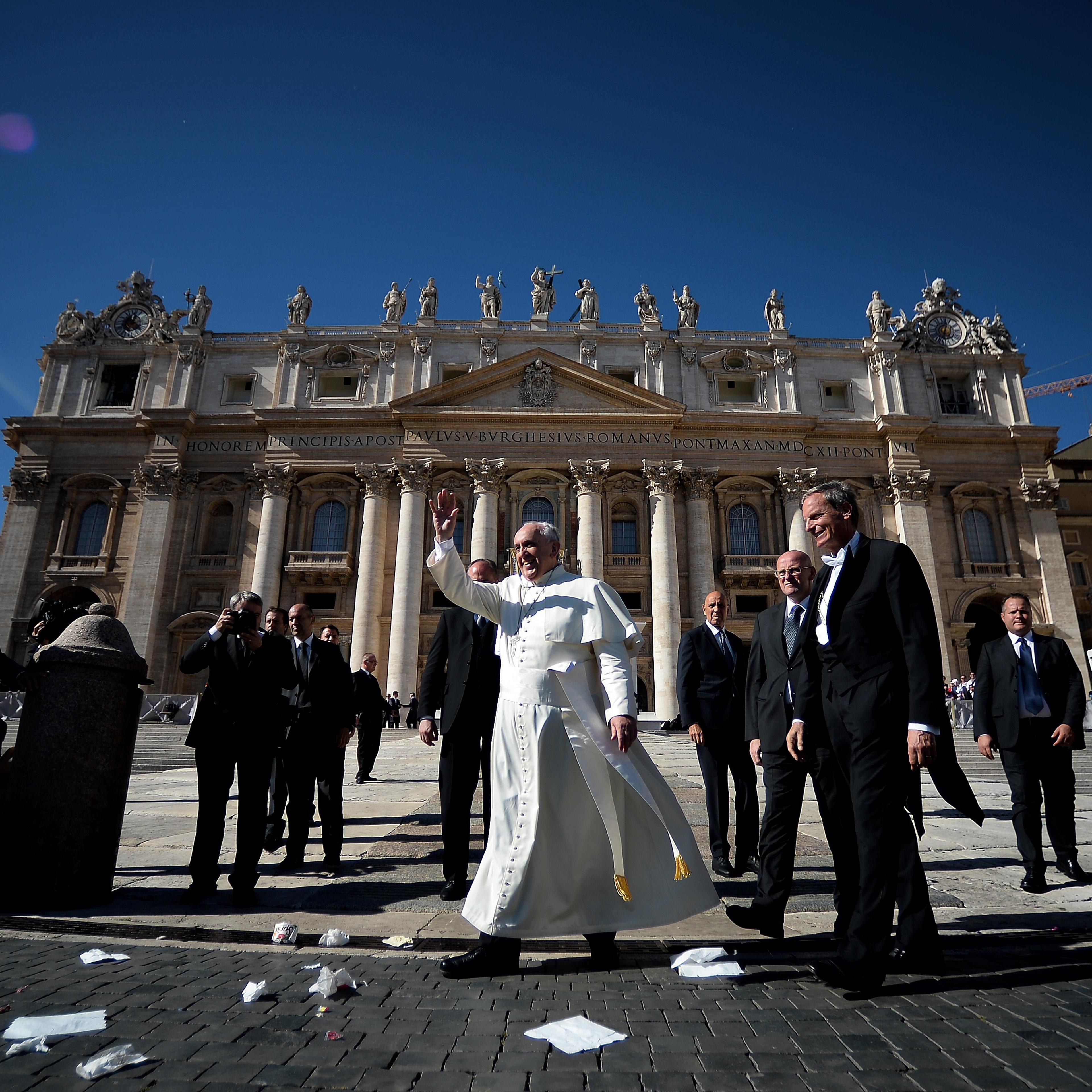 Pope Francis waves at the end of his weekly general audience on Saint-Peter's square at the Vatican on October 22, 2014.