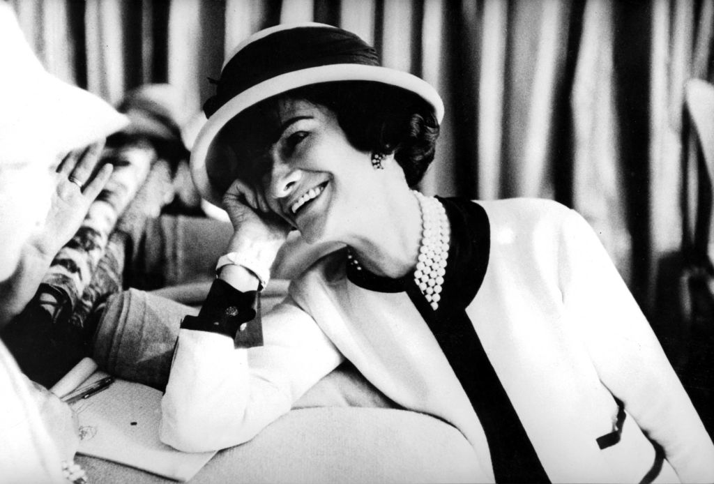 Coco Chanel in a classic Chanel white suit