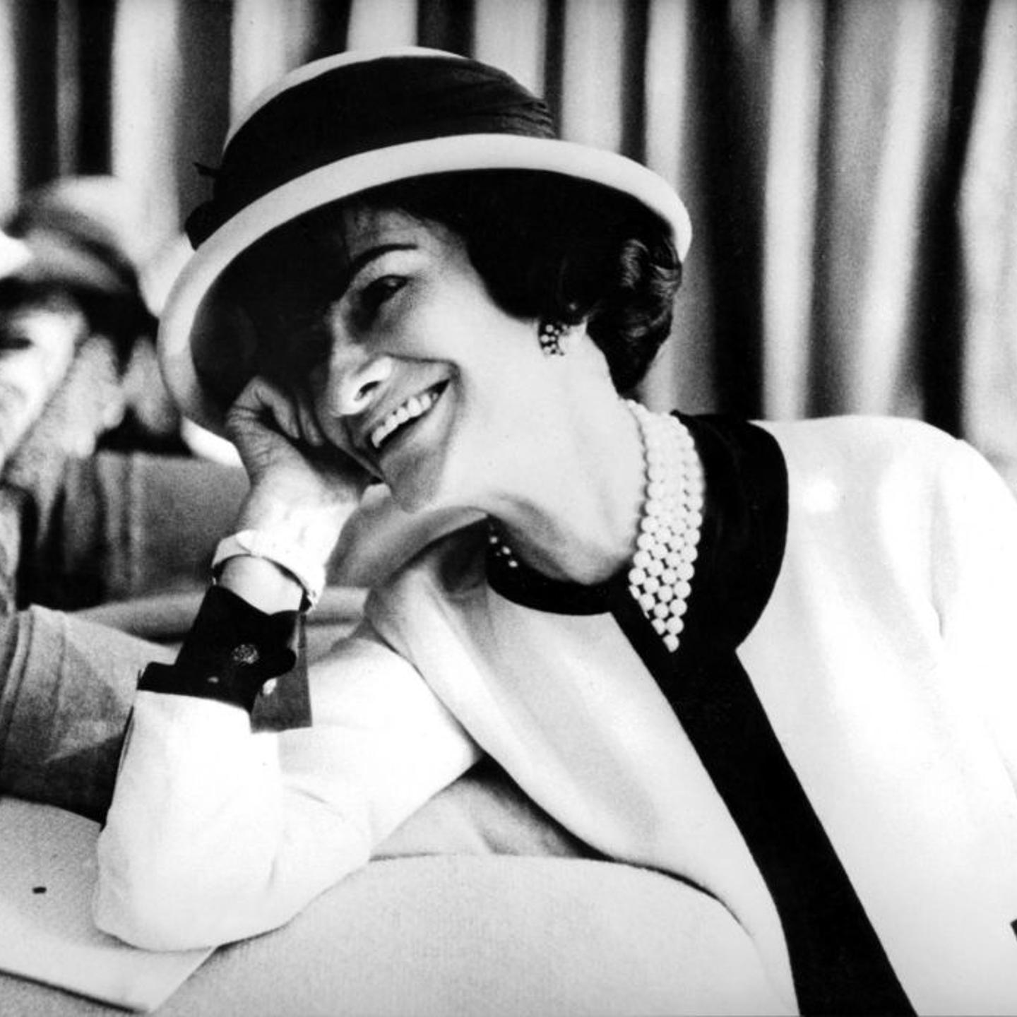 Coco Chanel in a classic Chanel white suit