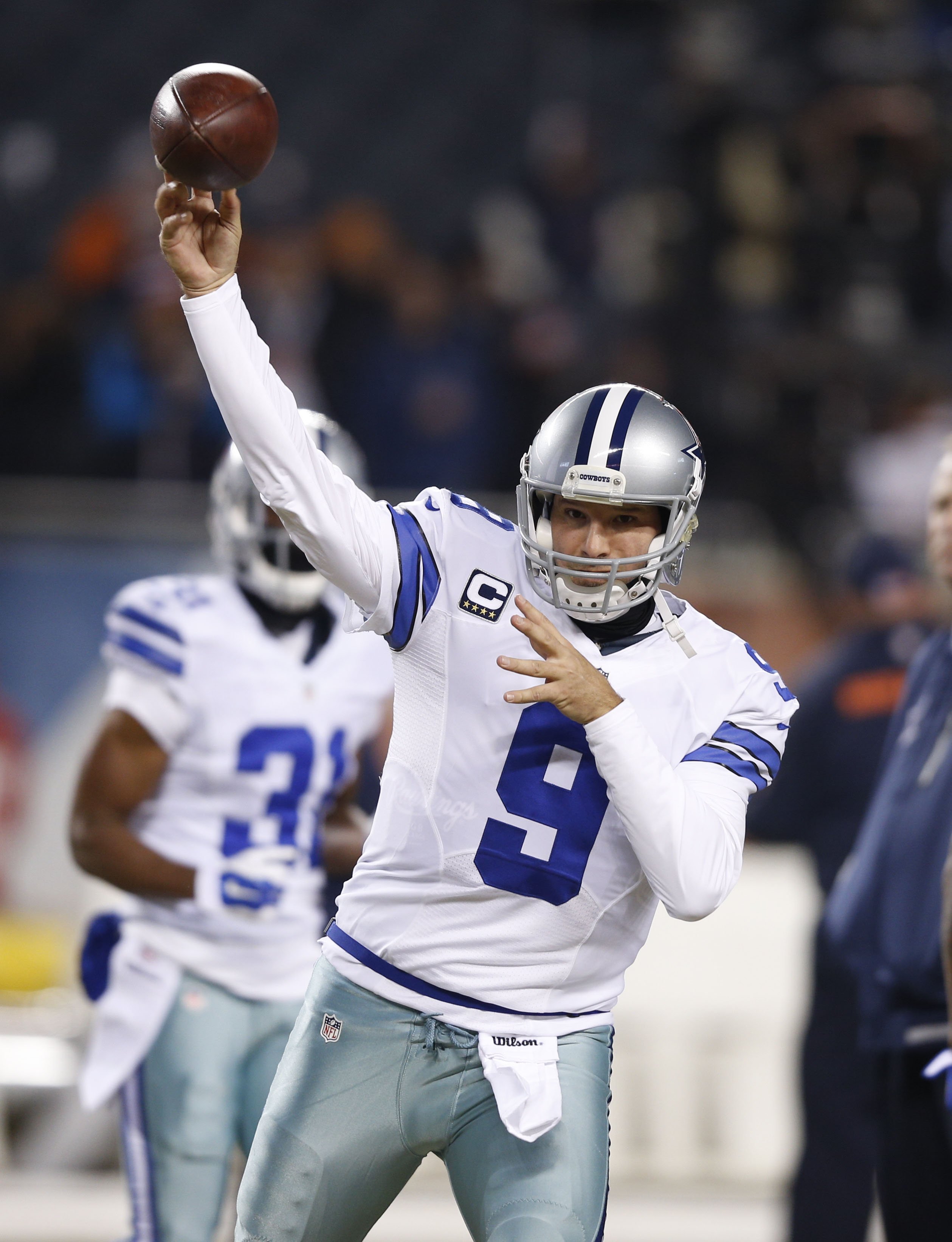 Tony Romo of the Dallas Cowboys warms up before a game against the Chicago Bears at Soldier Field on Dec. 4, 2014 in Chicago, Illinois.