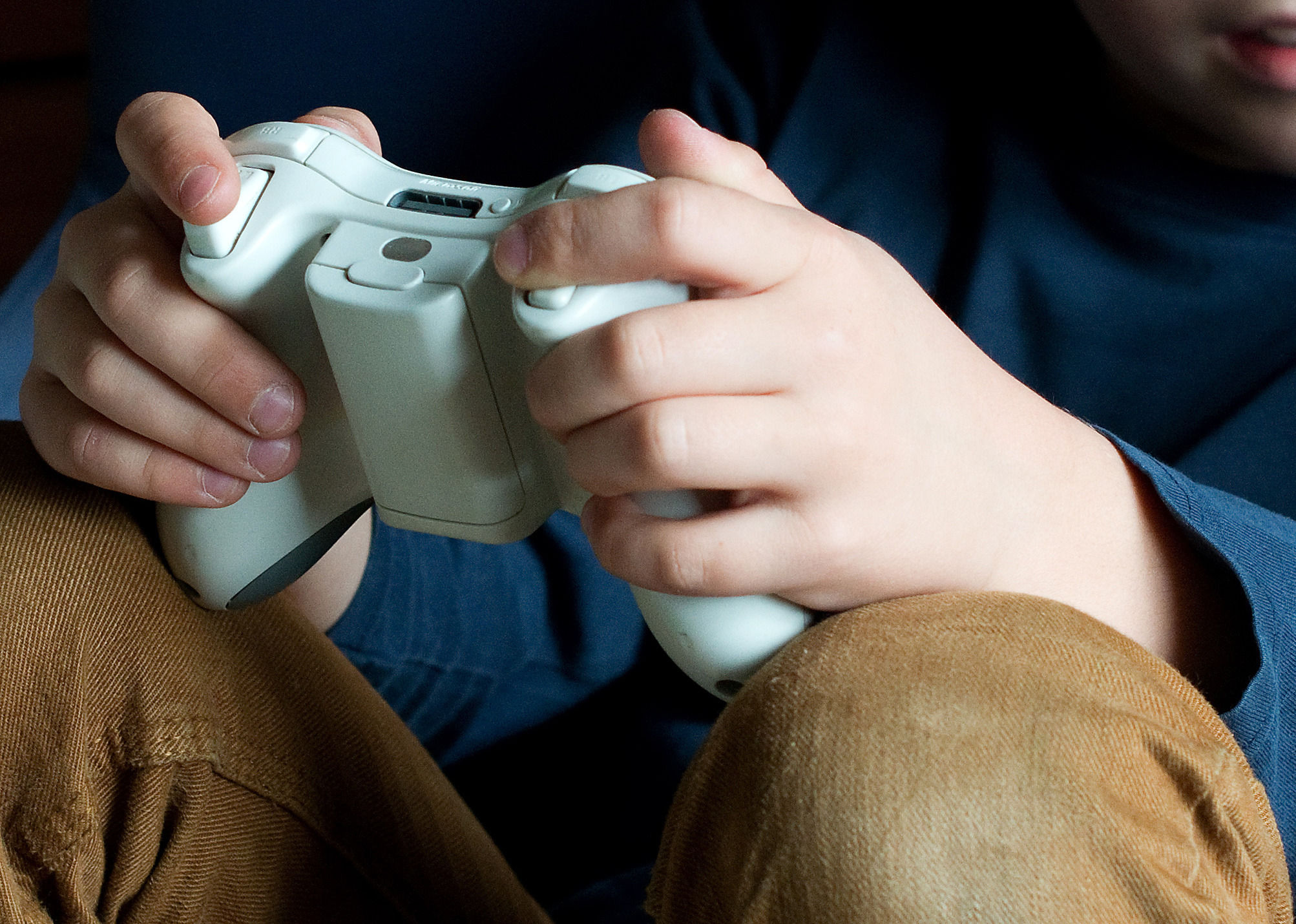 A seven year old boy plays with a Microsoft Xbox 360 on March 22, 2014 in Göttingen, Germany.