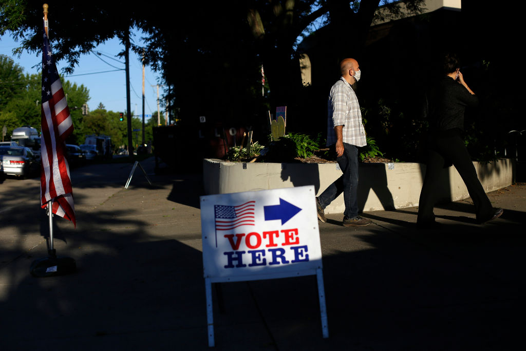 MINNEAPOLIS, MN - AUGUST 11: Voters wait in line at a polling s