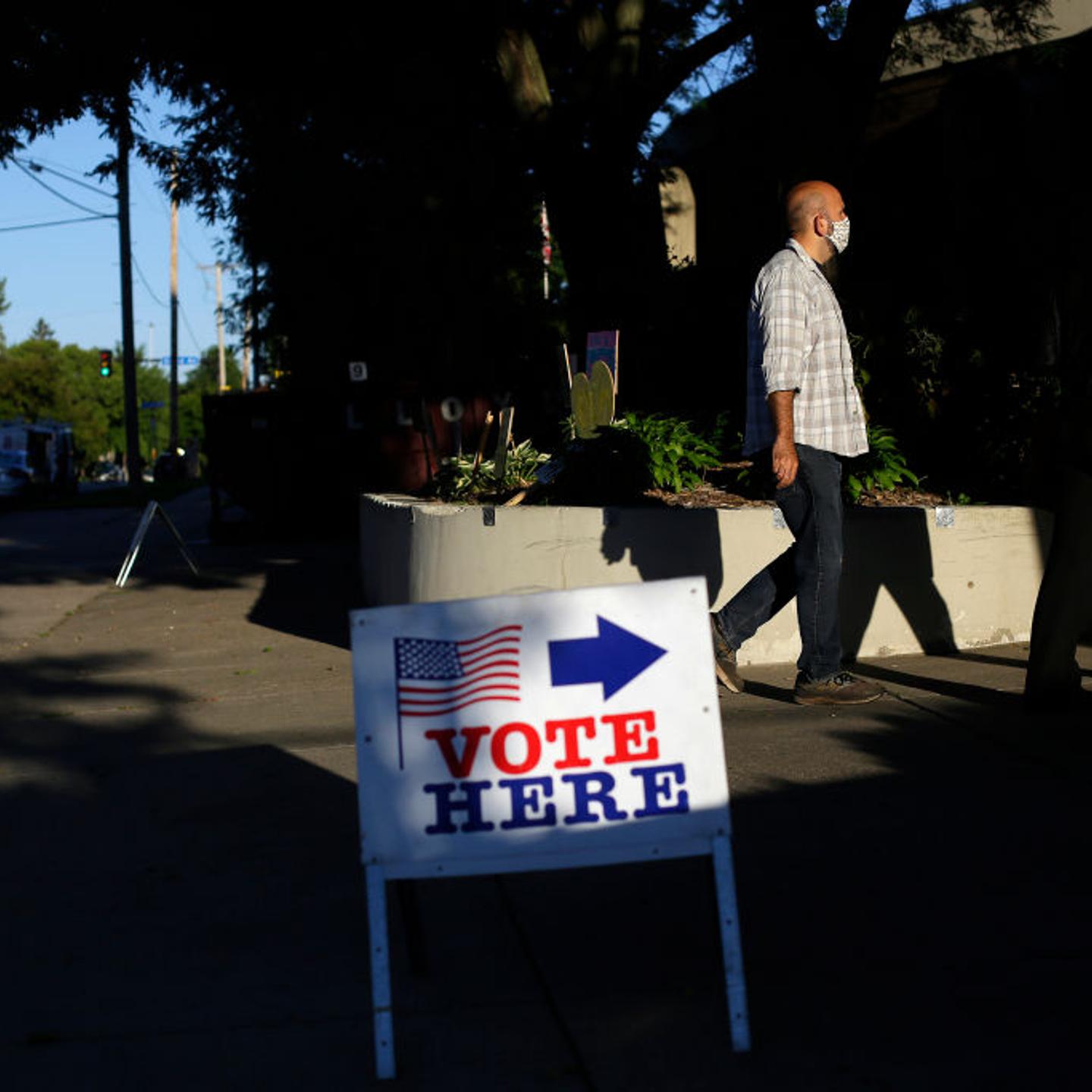 MINNEAPOLIS, MN - AUGUST 11: Voters wait in line at a polling s