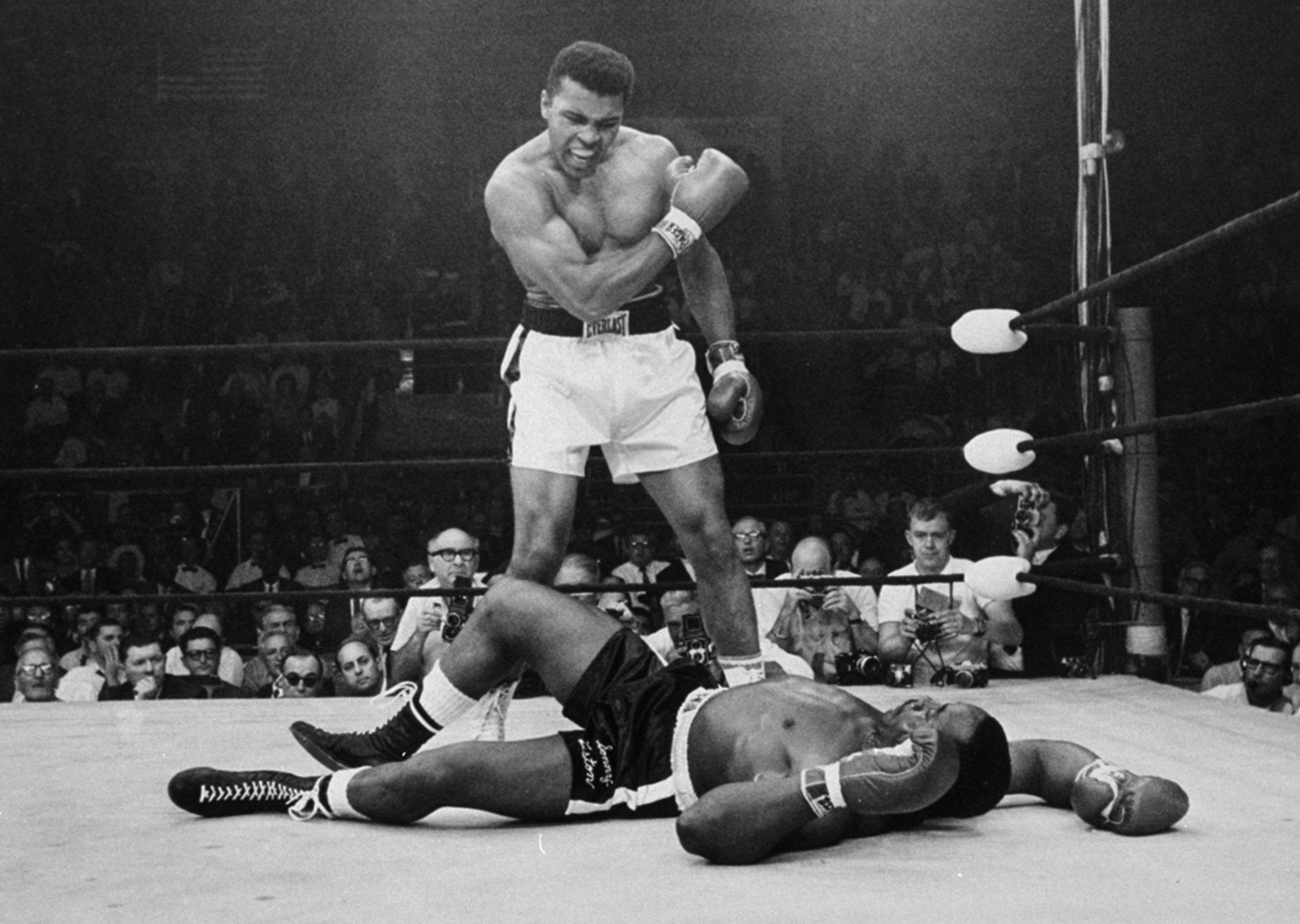 Heavyweight champion Muhammad Ali stands over fallen challenger Sonny Liston, shouting and gesturing shortly after dropping Liston with a short hard right to the jaw on May 25, 1965, in Lewiston, Maine. The bout lasted only one minute into the first roun