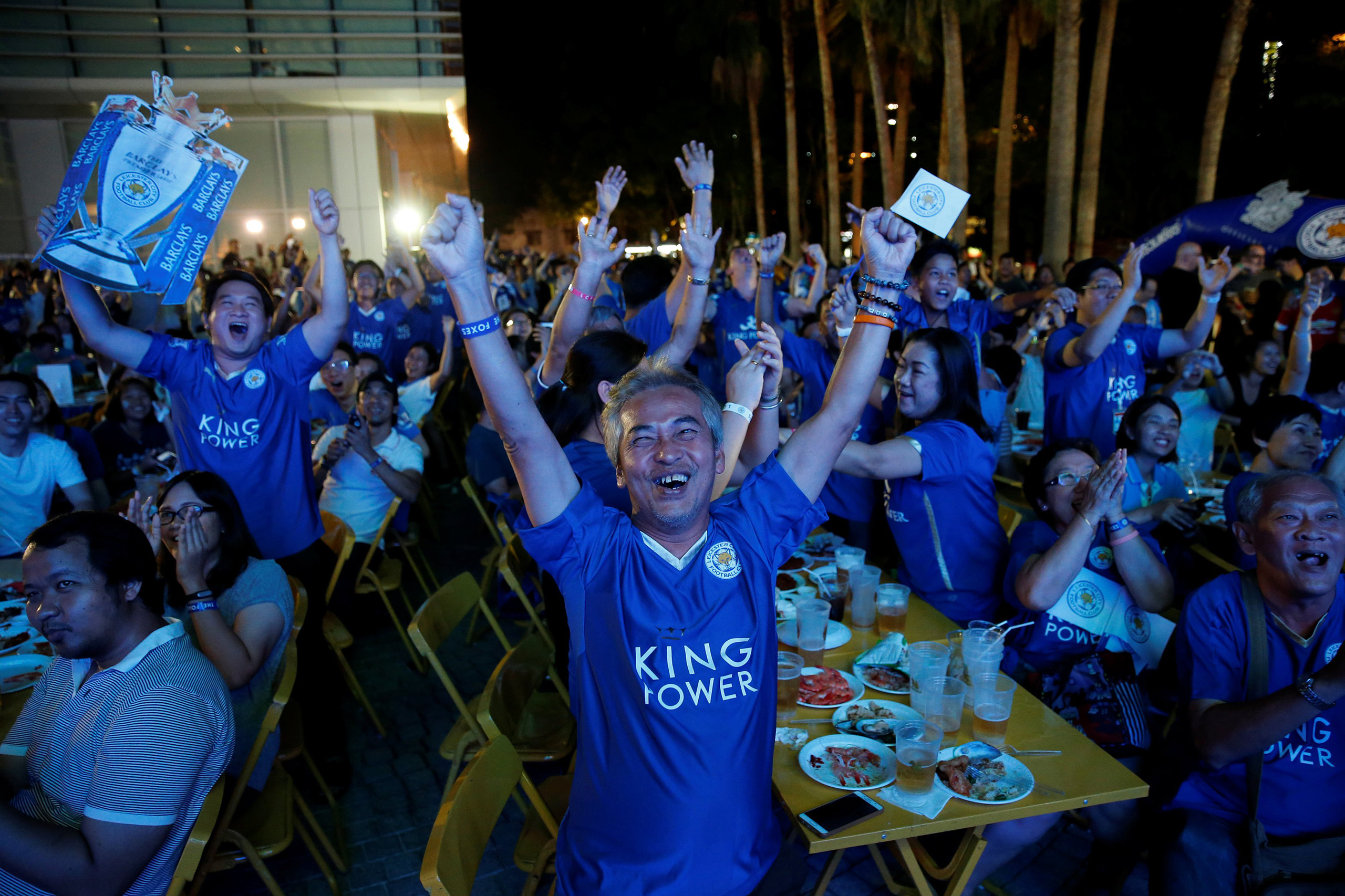 Leicester City fans celebrate after their team scores against Manchester United while watching the game on a big screen, in Bangkok, Thailand, May 1, 2016.