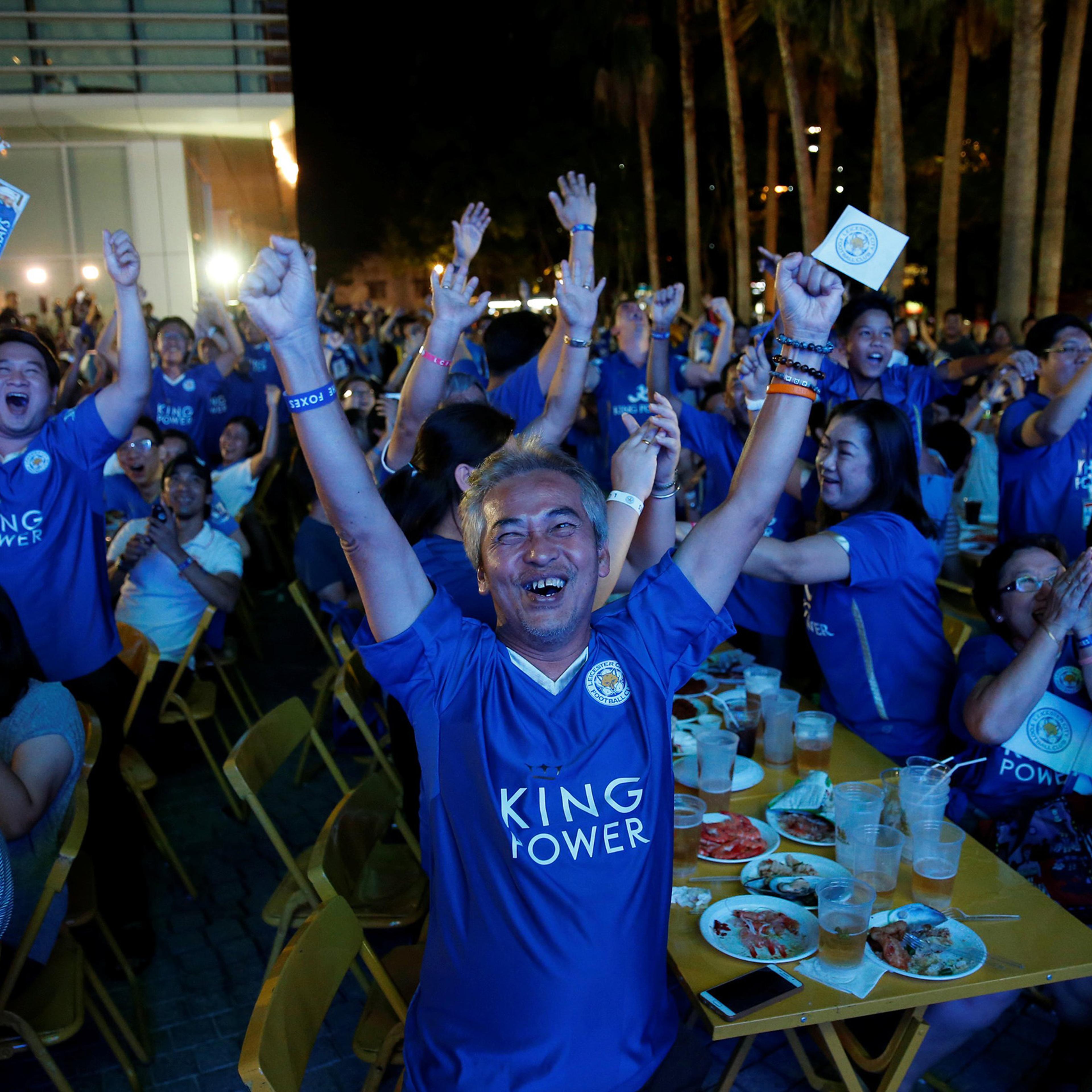 Leicester City fans celebrate after their team scores against Manchester United while watching the game on a big screen, in Bangkok, Thailand, May 1, 2016.