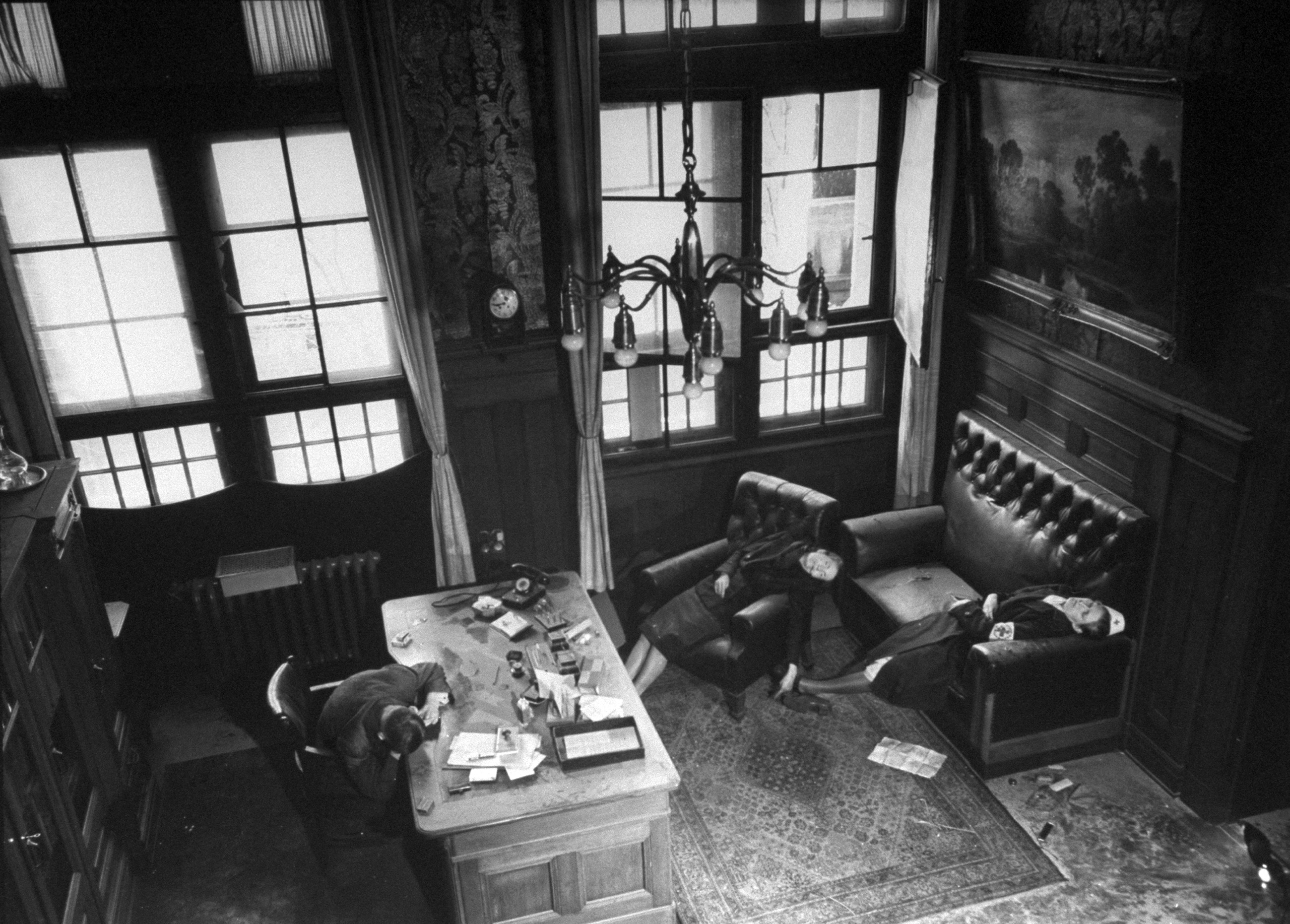 Leipzig City Council deputy mayor Dr. Lisso, member of Nazi party since 1932, lying dead while seated at his Town Hall desk, a suicide from cyanide, along with his wife and daughter.