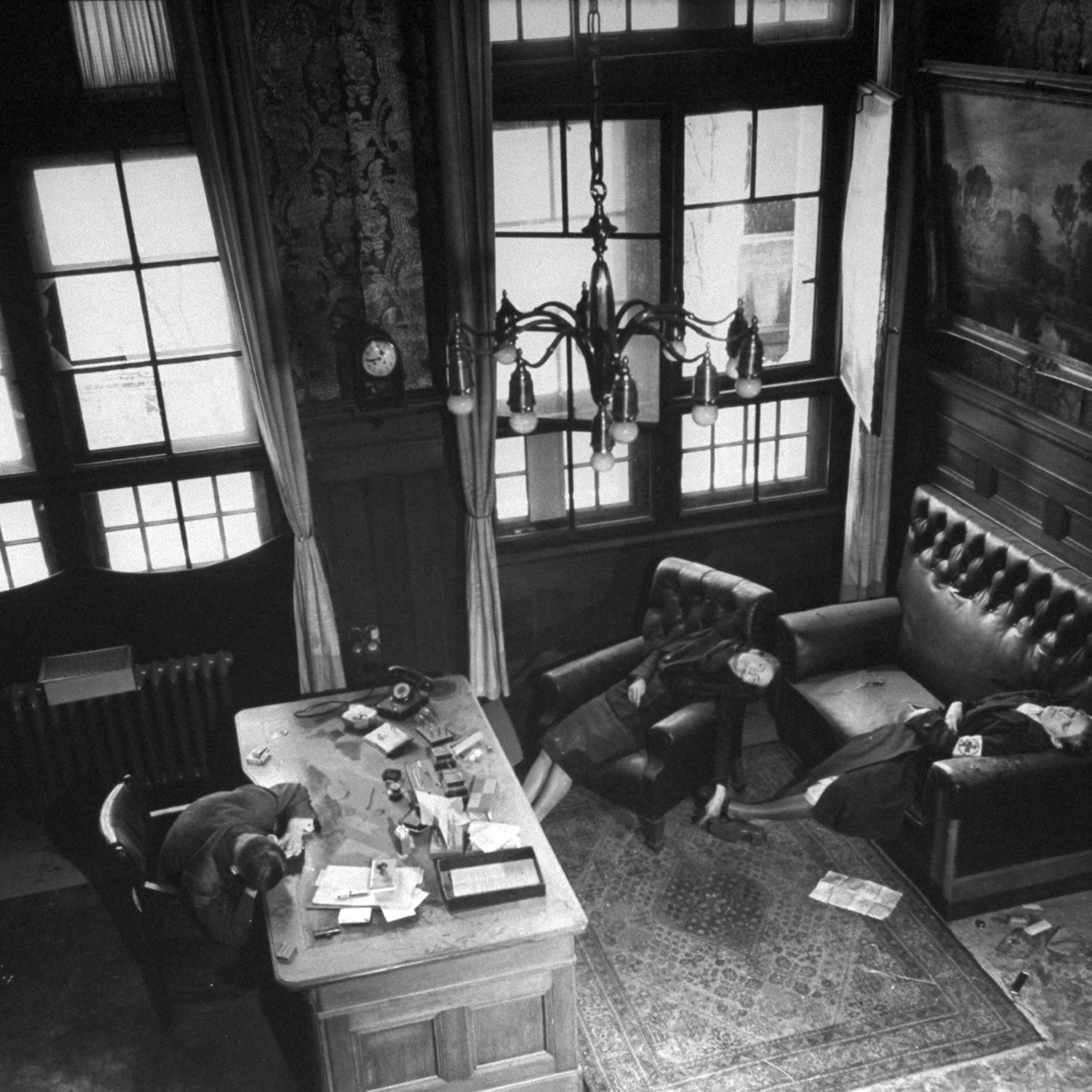 Leipzig City Council deputy mayor Dr. Lisso, member of Nazi party since 1932, lying dead while seated at his Town Hall desk, a suicide from cyanide, along with his wife and daughter.