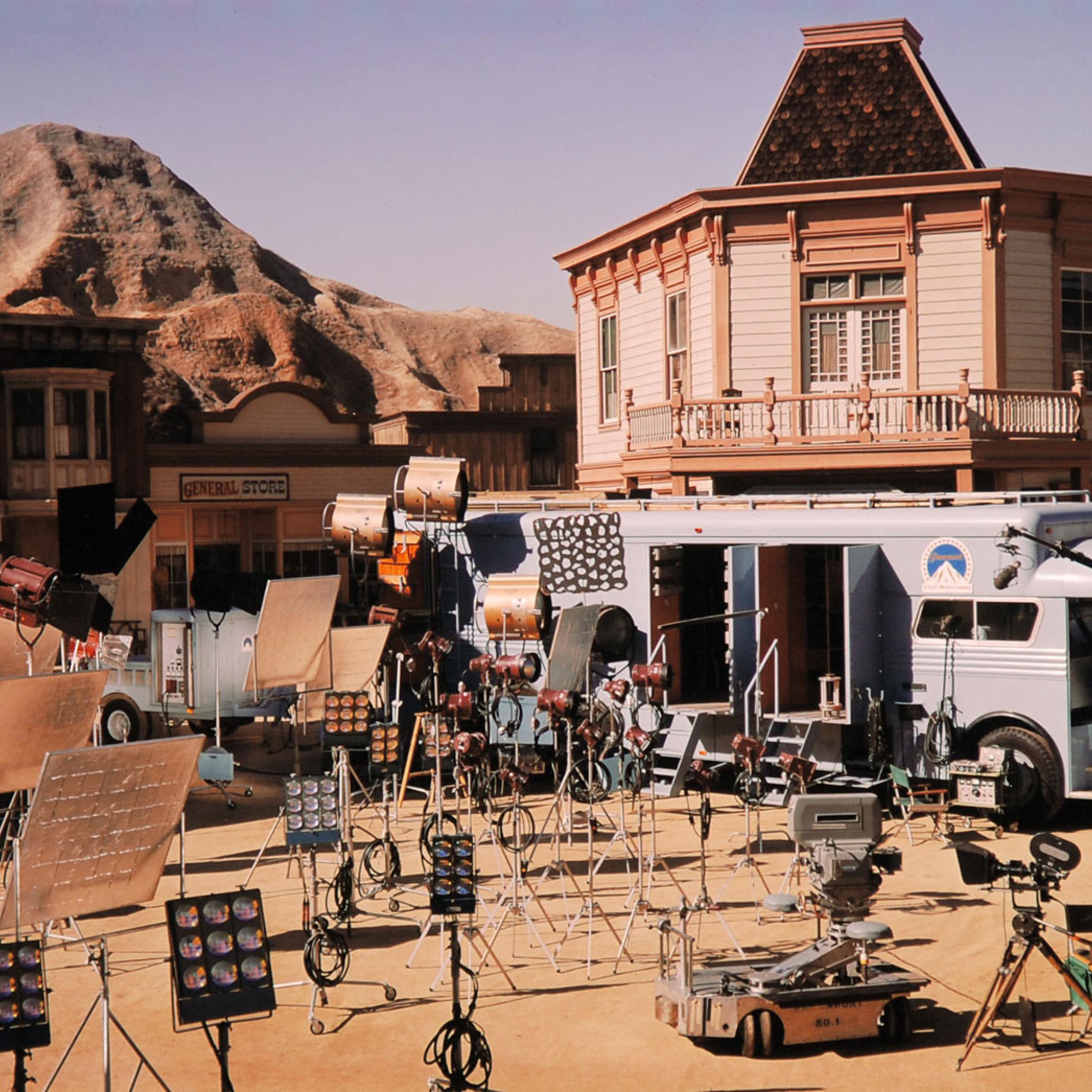 The scene of countless cowboy shoot-outs, a phony Western town drowses beneath a painted sky on the Paramount back lot.