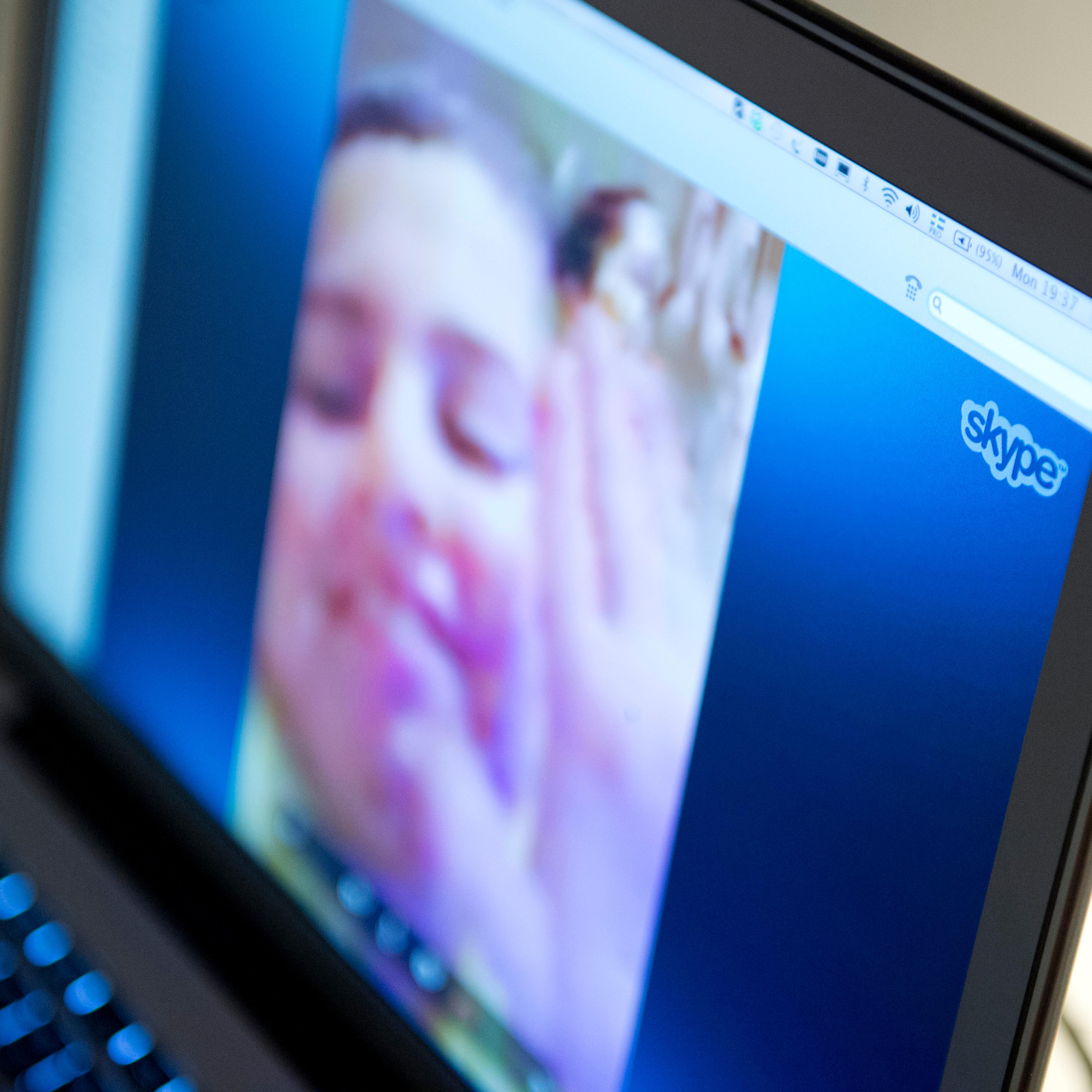 A woman communicates with her family abroad by using the Internet telephone system Skype on August 26, 2013 in Stockholm, Sweden.