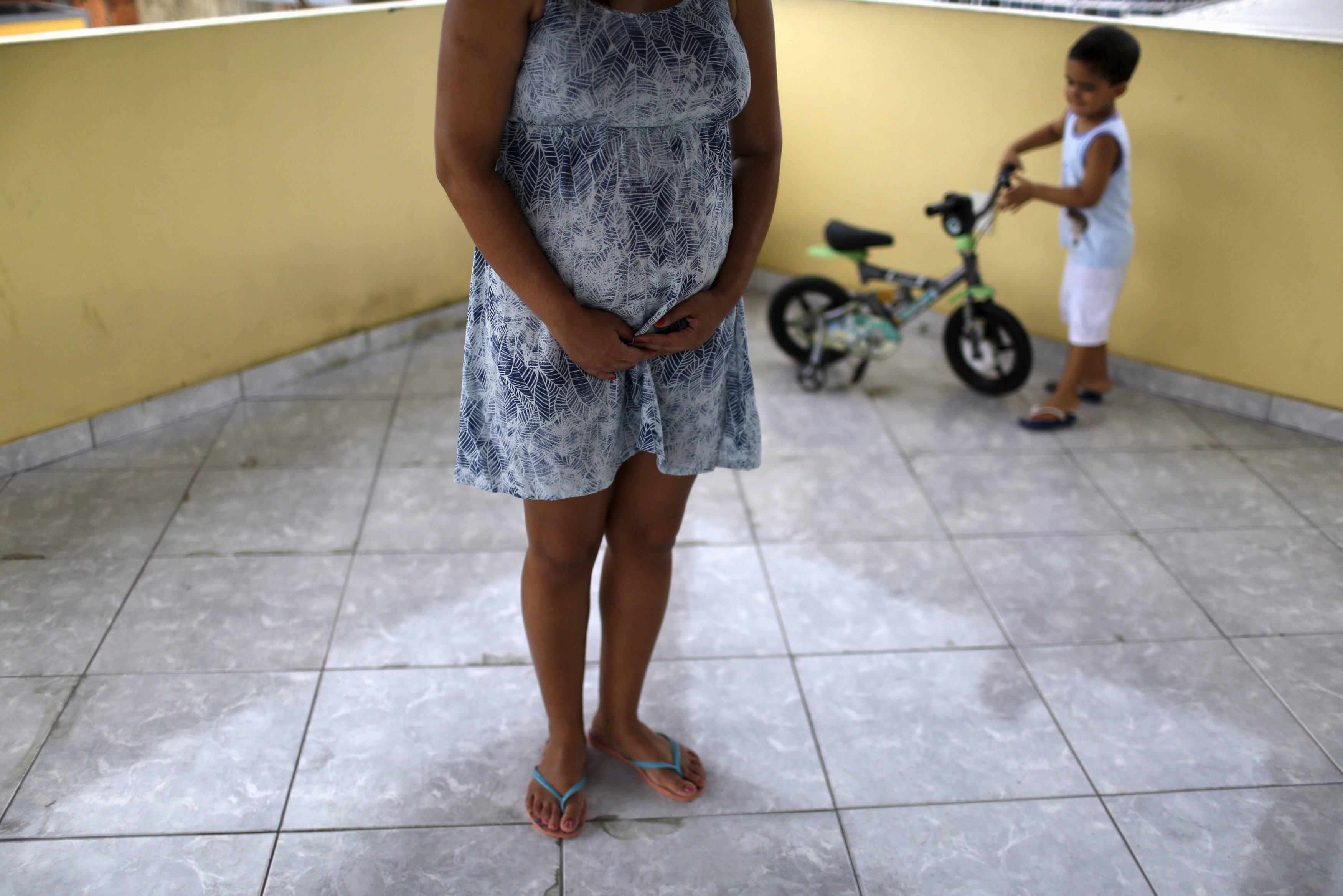 Gisele Felix, who is five months pregnant, stands on a terrace next to her son, Joao, at her home in Rio de Janeiro, Brazil, Jan. 28, 2016. Felix, who is concerned about the Zika virus, has not gone out of her house during her 30-day vacation, keeping al