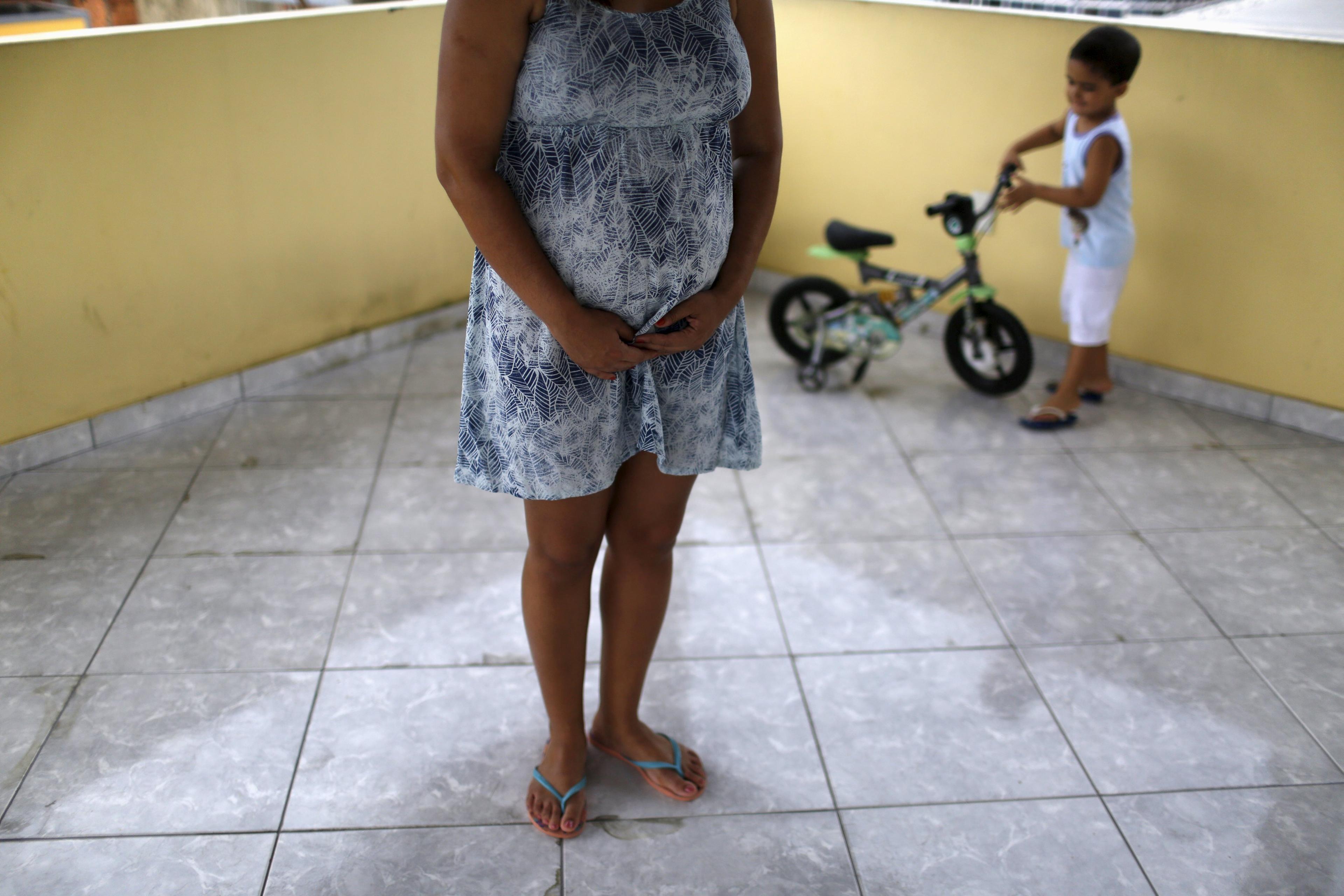Gisele Felix, who is five months pregnant, stands on a terrace next to her son, Joao, at her home in Rio de Janeiro, Brazil, Jan. 28, 2016. Felix, who is concerned about the Zika virus, has not gone out of her house during her 30-day vacation, keeping al