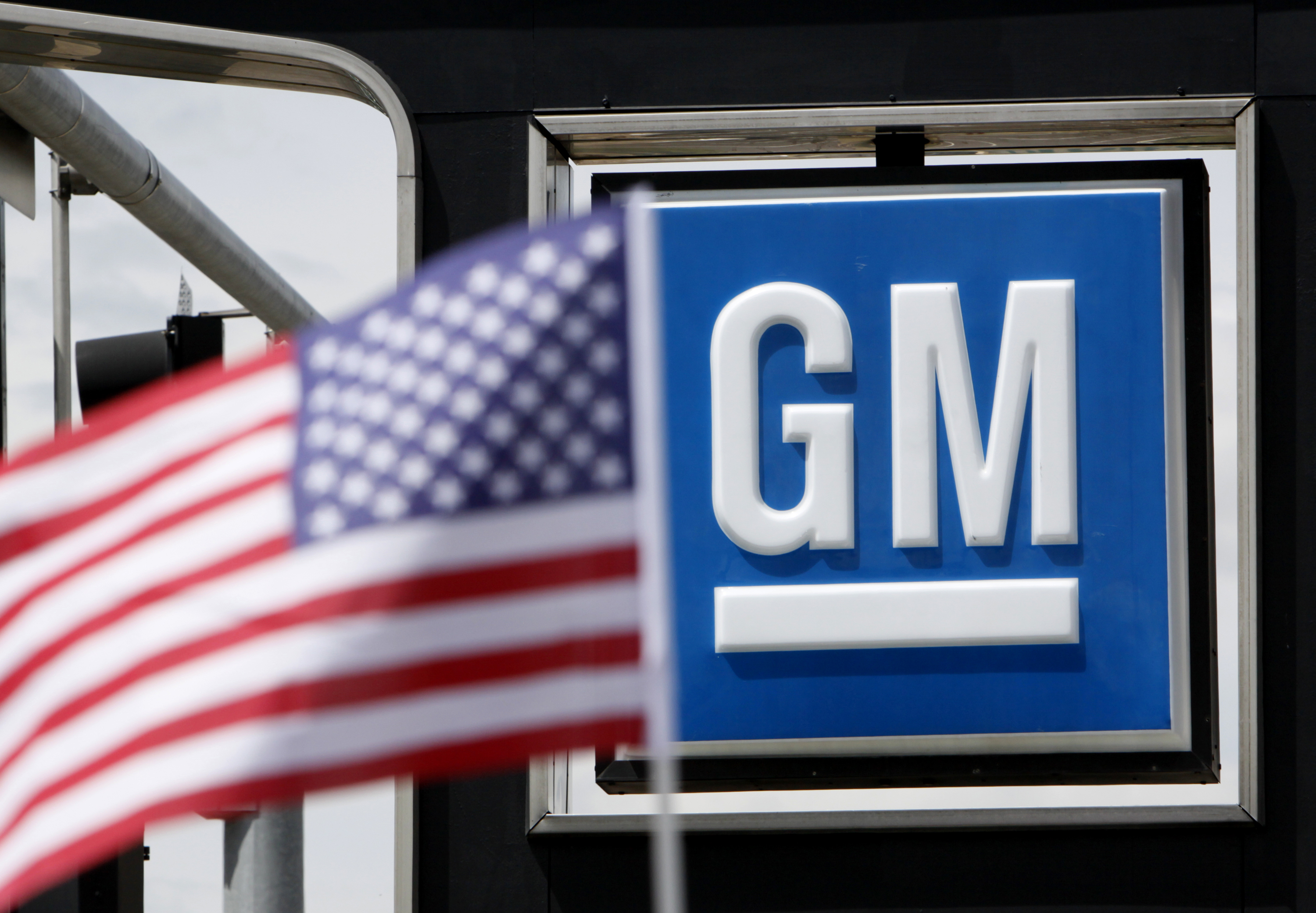 The U.S. flag flies at the Burt GM auto dealer in Denver.