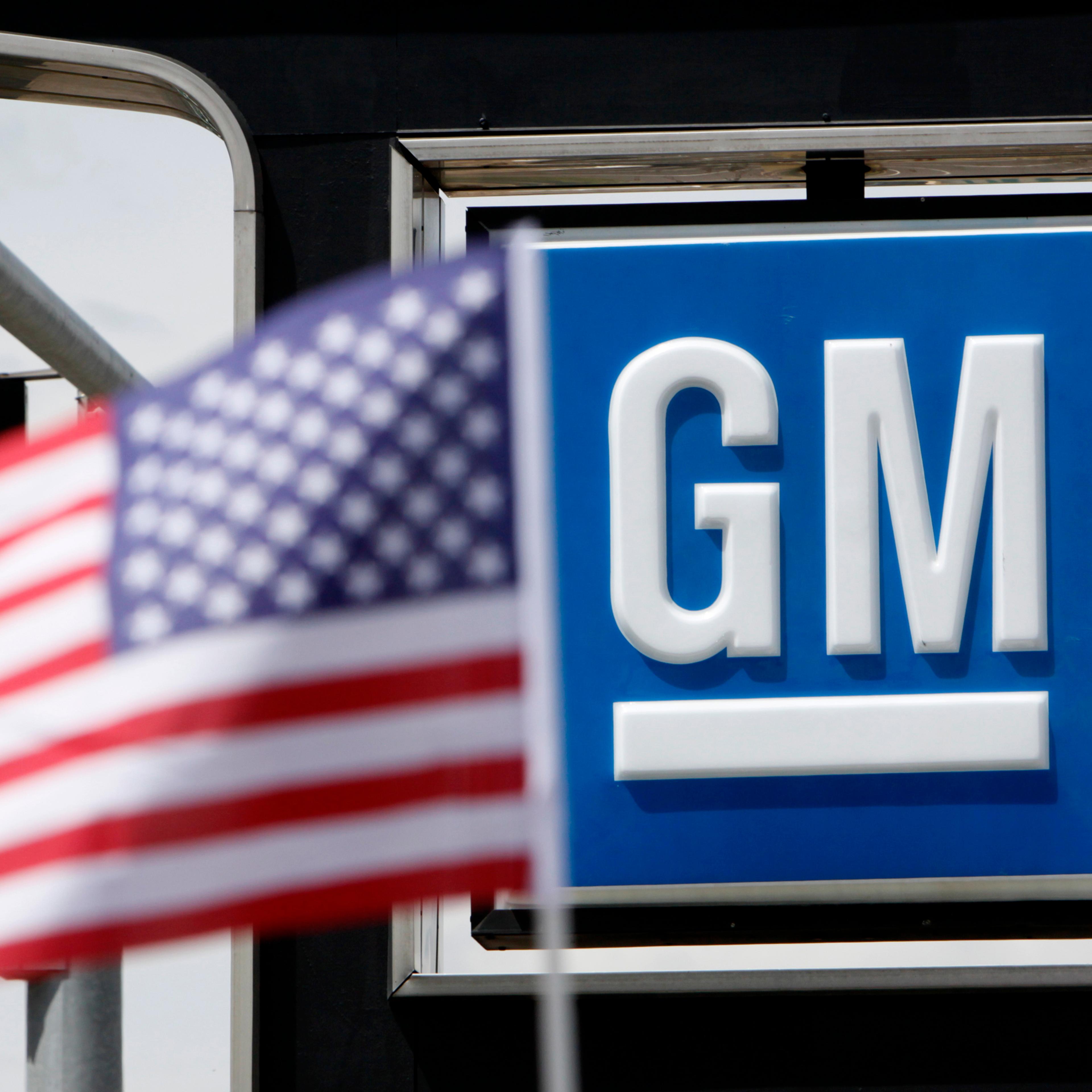 The U.S. flag flies at the Burt GM auto dealer in Denver.
